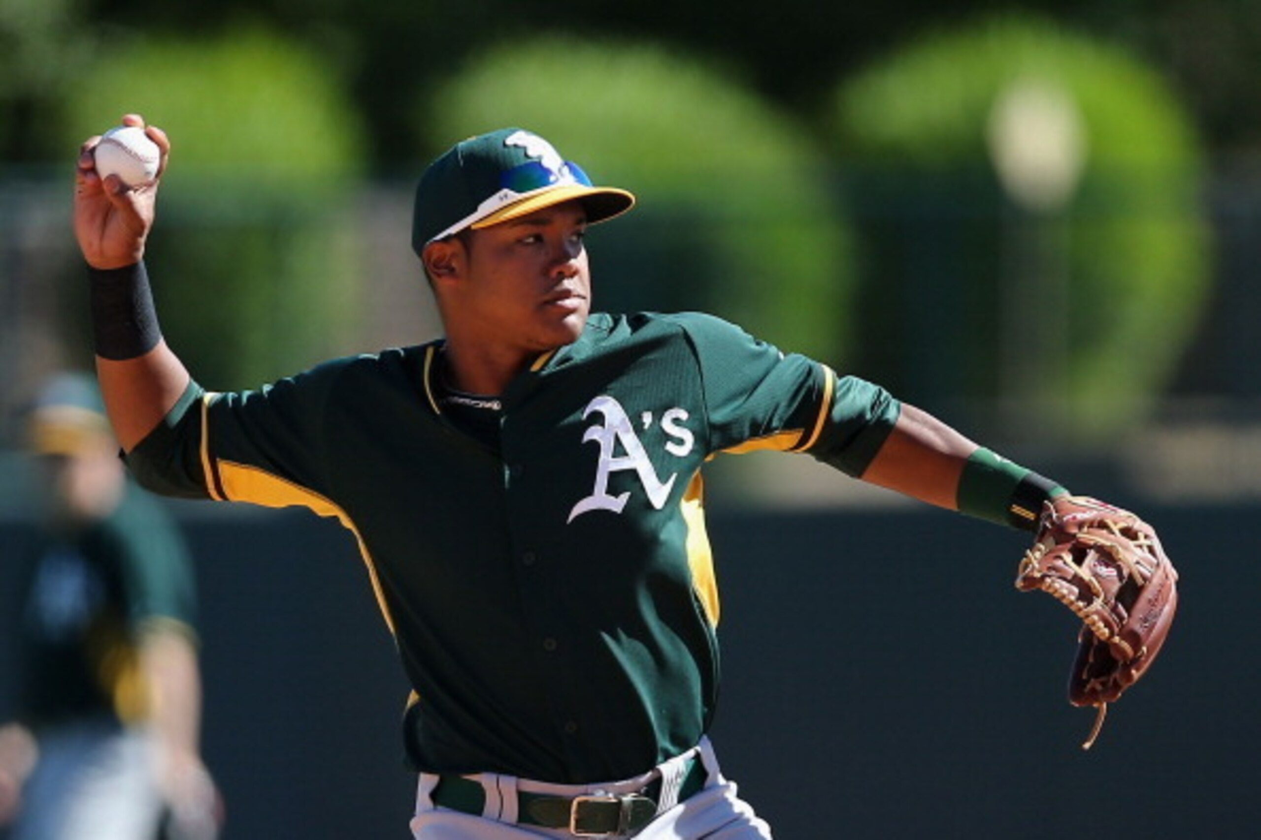 GLENDALE, AZ - MARCH 10:  Infielder Addison Russell #17 of the Oakland Athletics warms up during the spring training game against the Los Angeles Dodgers at Camelback Ranch on March 10, 2014 in Glendale, Arizona.  (Photo by Christian Petersen/Getty Images