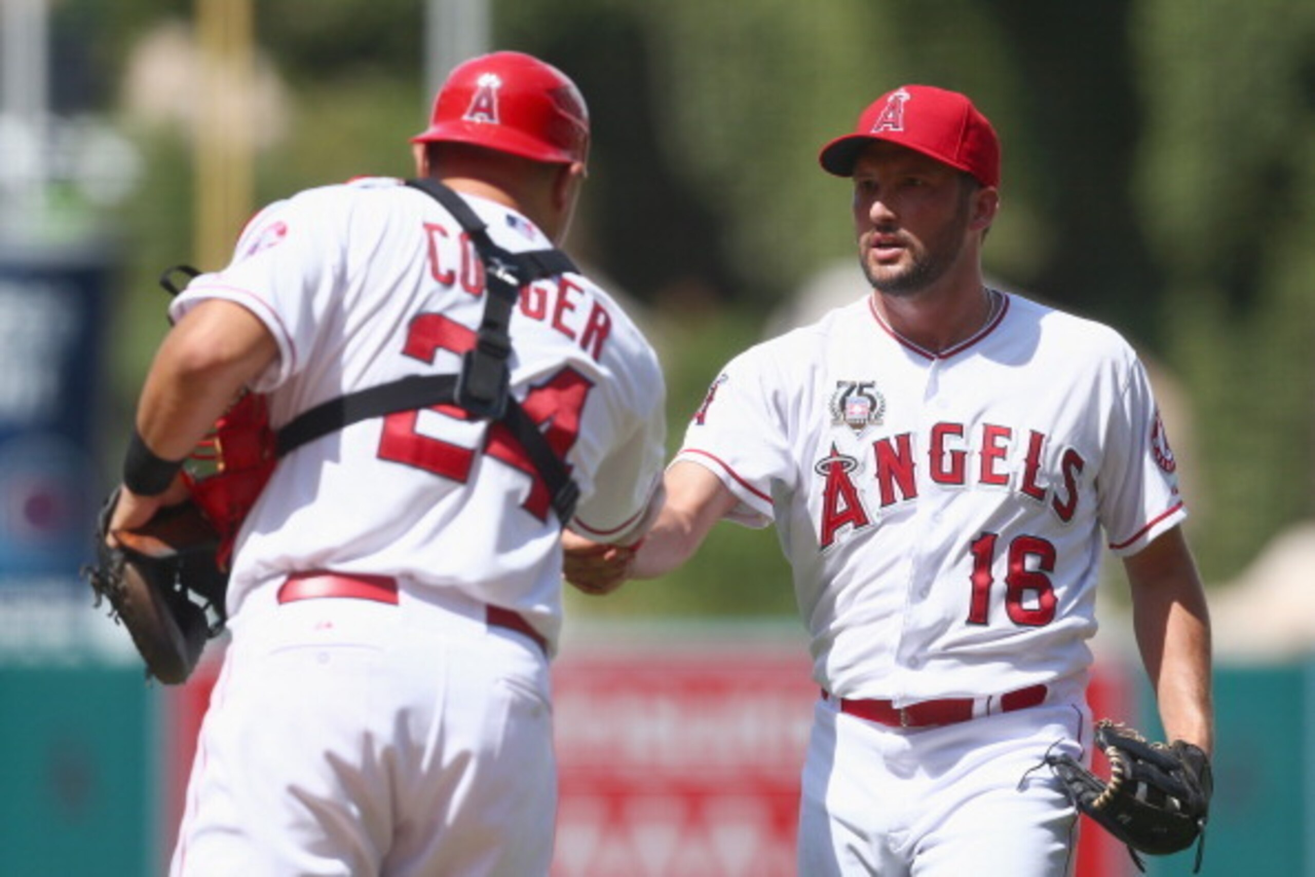 ANAHEIM, CA - JULY 27:  Closing pitcher Huston Street #16 of the Los Angeles Angels of Anaheim is congratulated by catcher Hank Conger #24 after earning a save against the Detroit Tigers at Angel Stadium of Anaheim on July 27, 2014 in Anaheim, California.