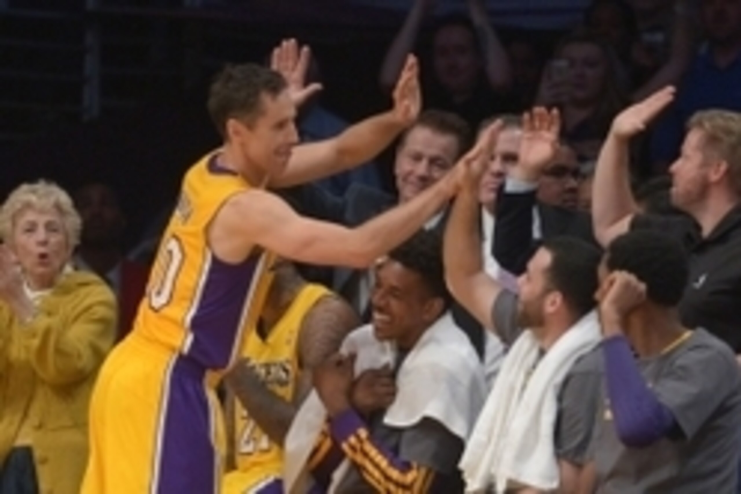 Apr 8, 2014; Los Angeles, CA, USA; Los Angeles Lakers guard Steve Nash (10) is congratulated by teammates Jodie Meeks (10), Nick Young (0) and Jordan Farmar (1) after passing Mark Jackson (not pictured) to move into third on the all-time NBA assist list i