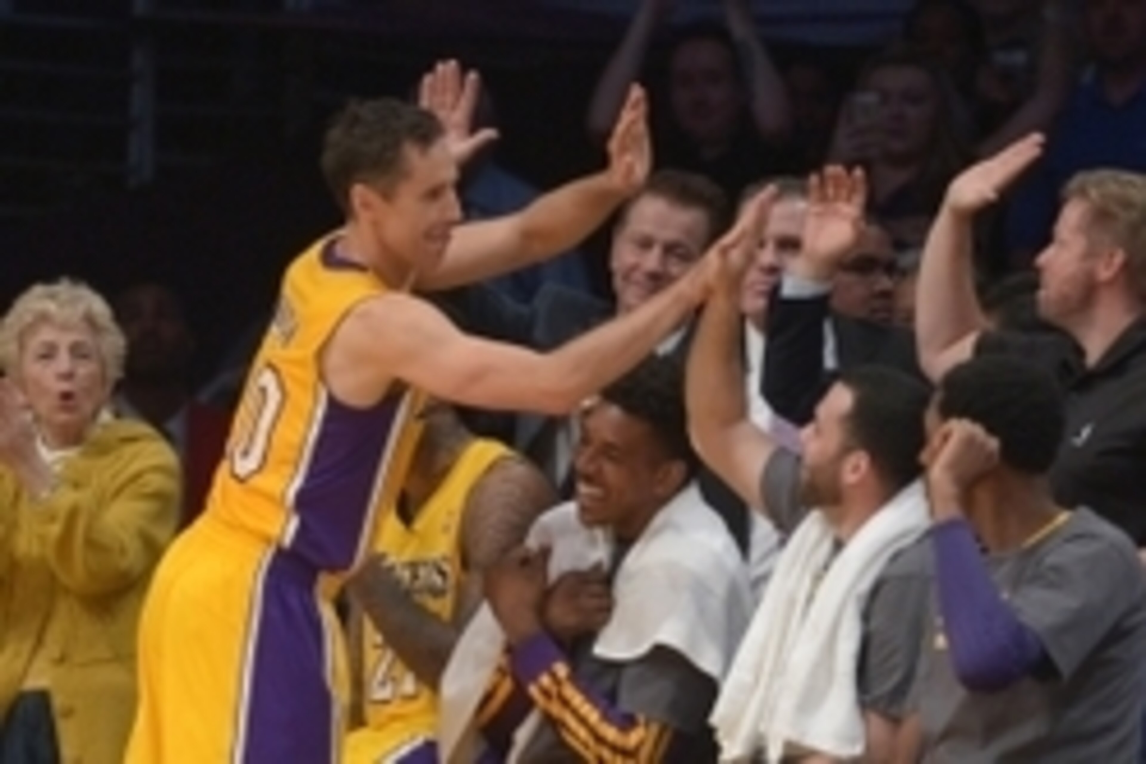 Apr 8, 2014; Los Angeles, CA, USA; Los Angeles Lakers guard Steve Nash (10) is congratulated by teammates Jodie Meeks (10), Nick Young (0) and Jordan Farmar (1) after passing Mark Jackson (not pictured) to move into third on the all-time NBA assist list i