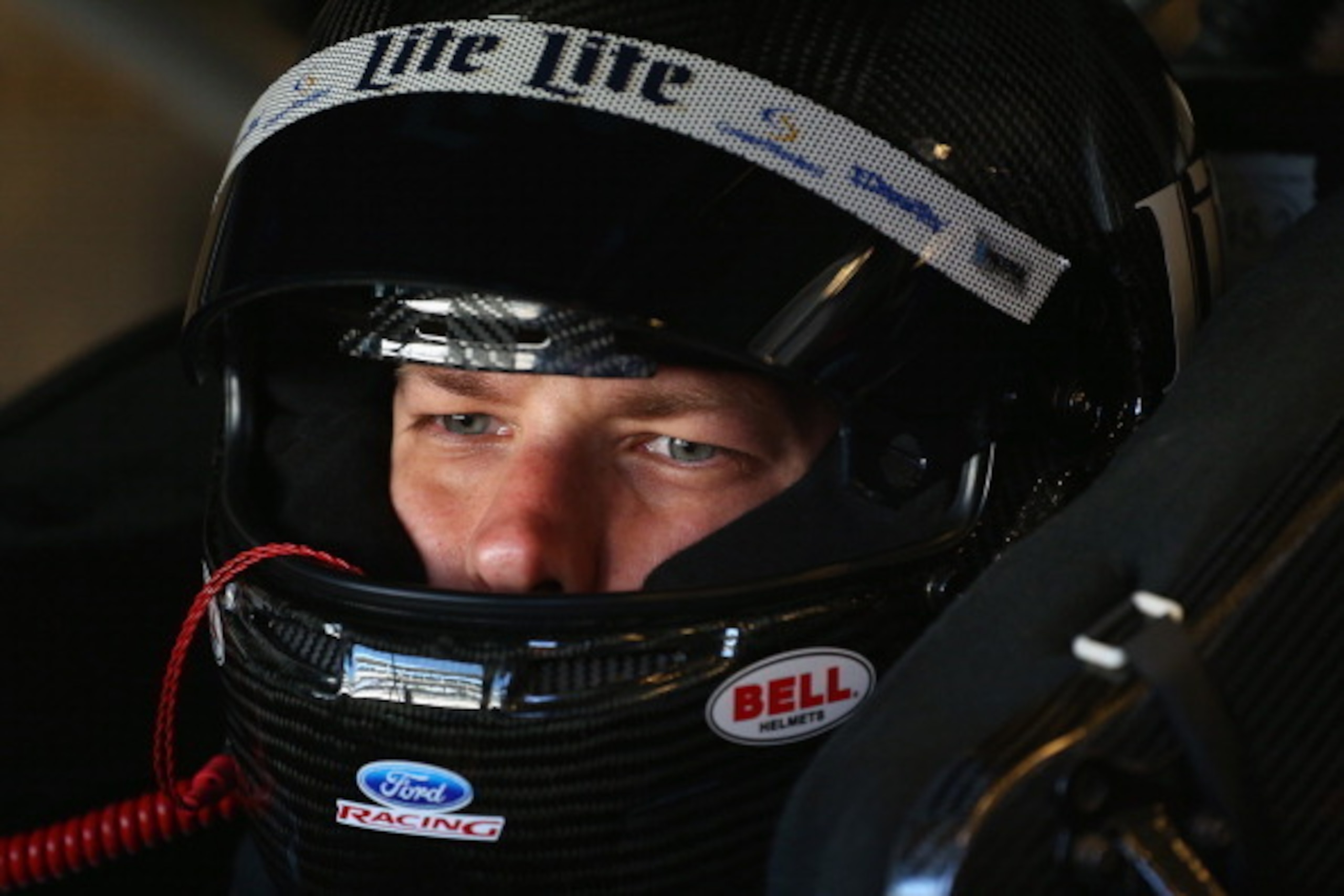 INDIANAPOLIS, IN - JULY 25:  Brad Keselowski, driver of the #2 Miller Lite Ford, sits in his car in the garage area during practice for the NASCAR Sprint Cup Series Crown Royal Presents, the John Wayne Walding 400 at The Brickyard at Indianapolis Motor Sp