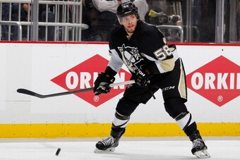 PITTSBURGH, PA - MAY 4:  Kris Letang #58 of the Pittsburgh Penguins moves the puck against the New York Rangers in Game Two of the Second Round of the 2014 Stanley Cup Playoffs at Consol Energy Center on May 4, 2014 in Pittsburgh, Pennsylvania.  (Photo by