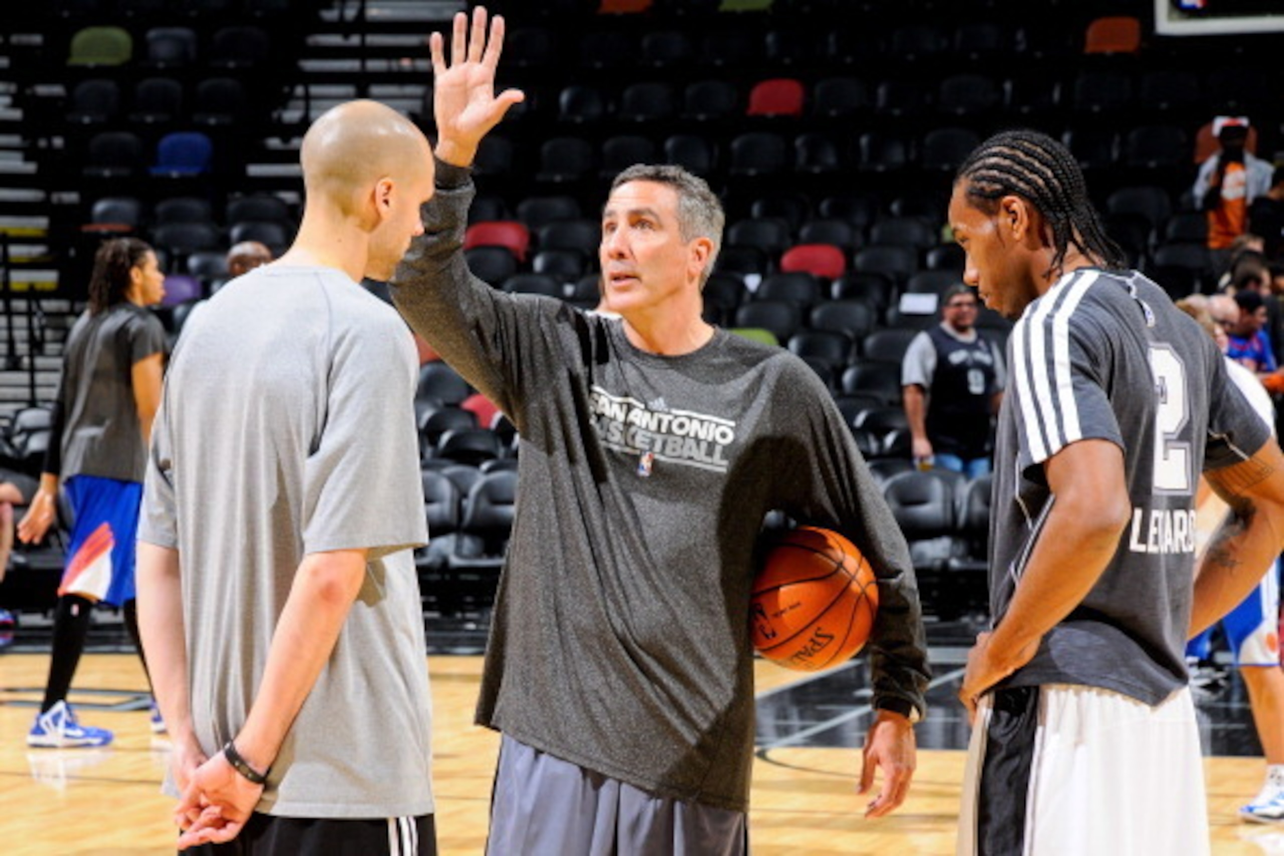 SAN ANTONIO, TX - NOVEMBER 15: Chip Engelland, assistant coach of the San Antonio Spurs, center, speaks with Kawhi Leonard #2 before a game against the New York Knicks on November 15, 2012 at the AT&T Center in San Antonio, Texas. NOTE TO USER: User expre