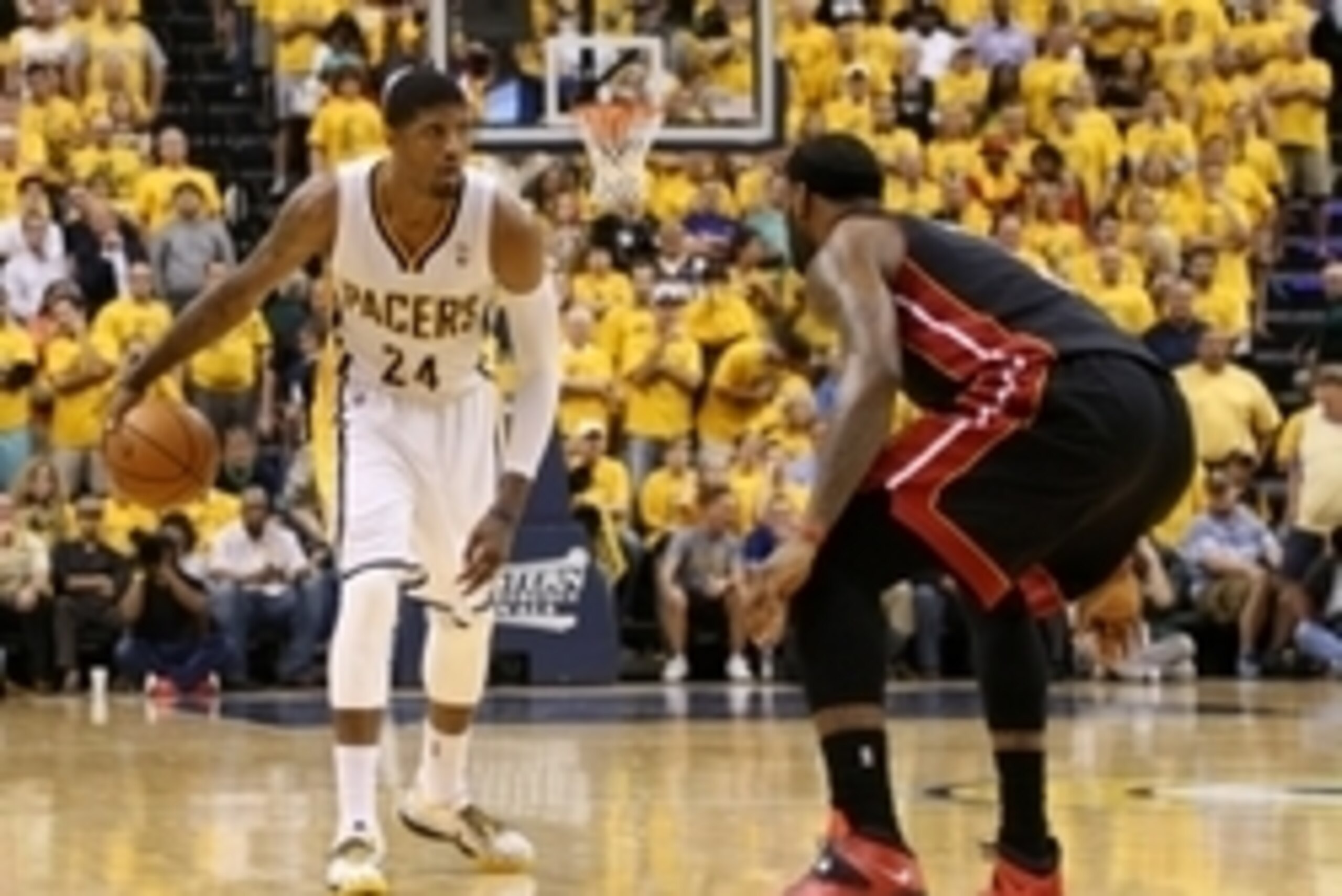 May 28, 2014; Indianapolis, IN, USA; Indiana Pacers forward Paul George (24) brings the ball upcourt as Miami Heat forward LeBron James (6) defends during the fourth quarter in game five of the Eastern Conference Finals of the 2014 NBA Playoffs at Bankers