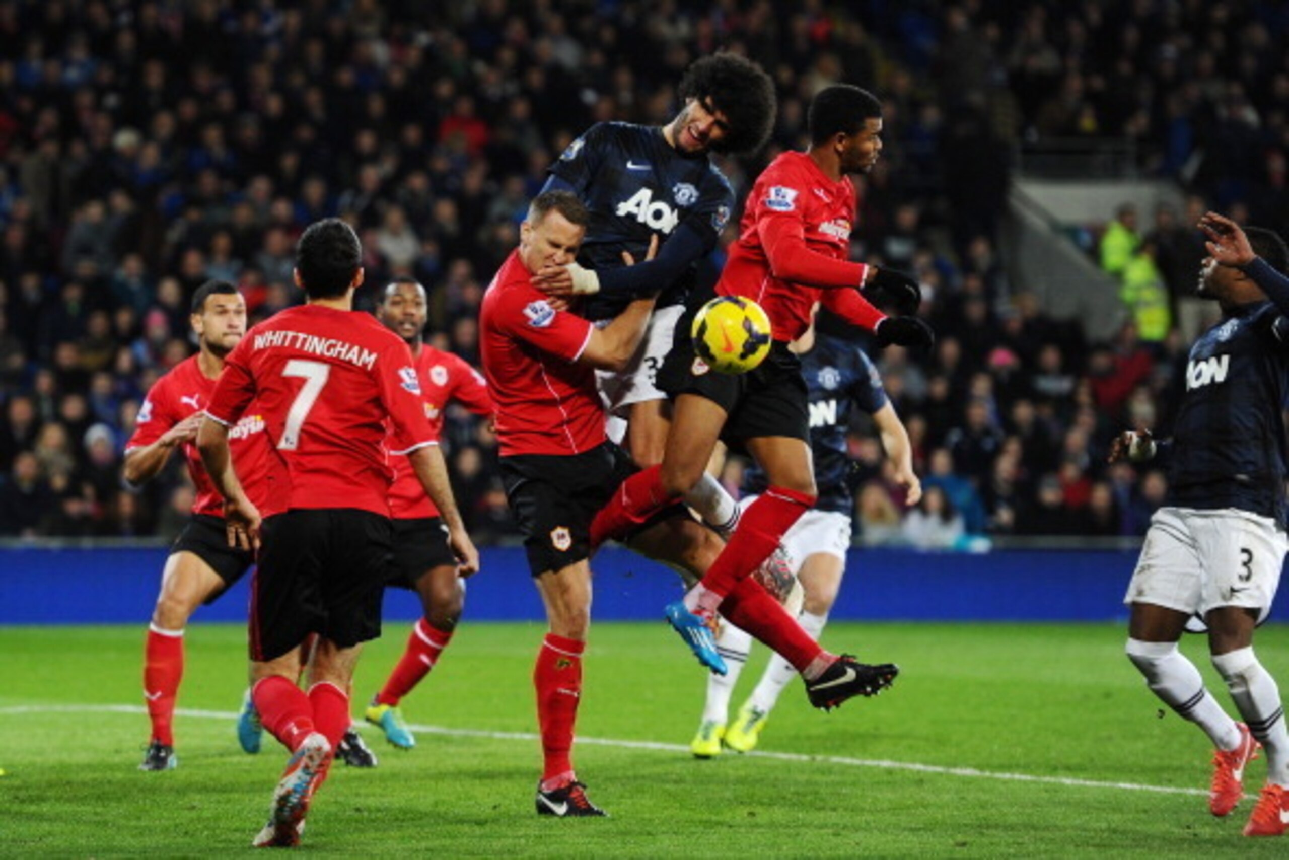 CARDIFF, WALES - NOVEMBER 24:  Marouane Fellaini of Manchester United battles for a header with Ben Turner and Fraizer Campbell of Cardiff during the Barclays Premier League match between Cardiff City and Manchester United at Cardiff City Stadium on Novem