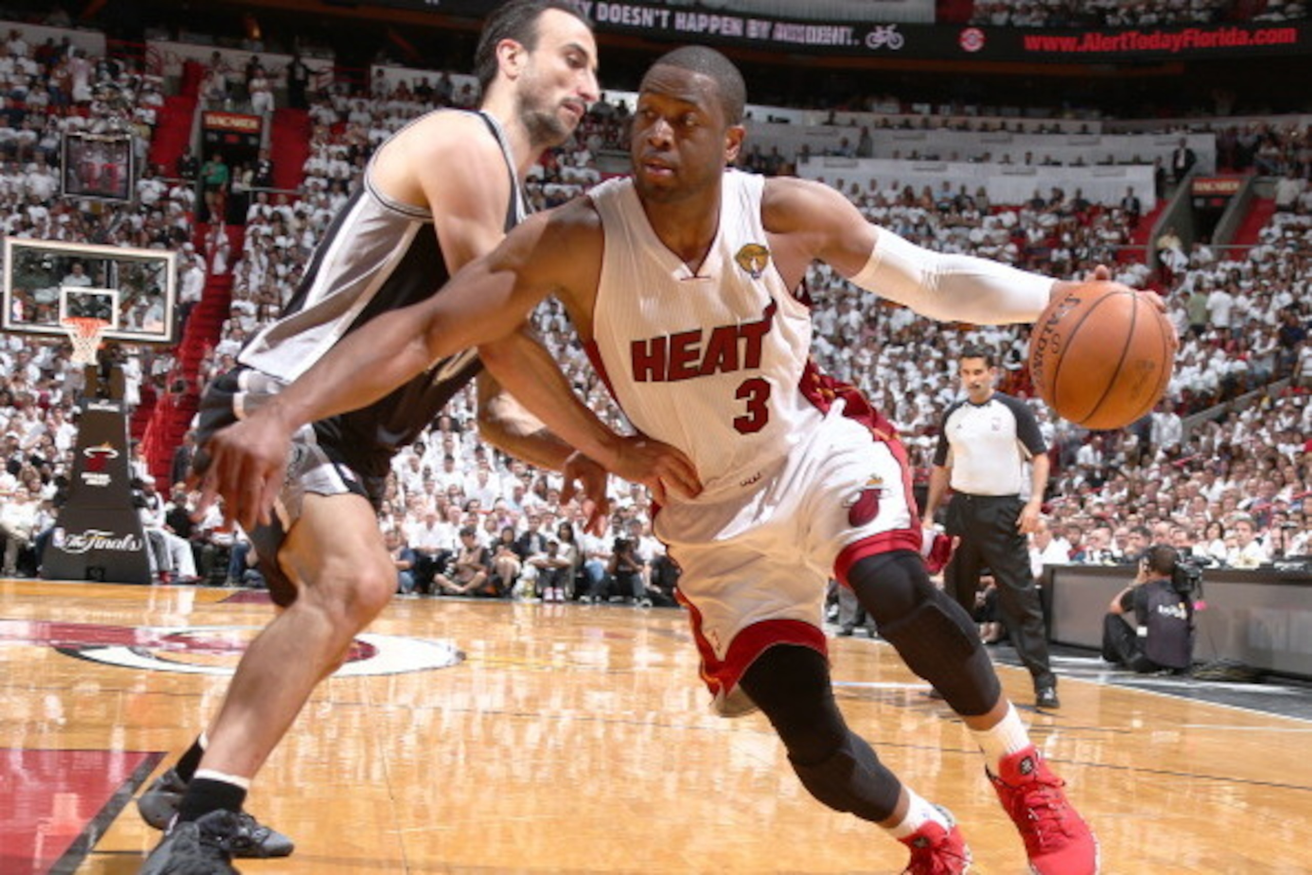 MIAMI, FL - JUNE 10: Dwyane Wade #3 of the Miami Heat drives against Manu Ginobili #20 of the San Antonio Spurs during Game Three of the 2014 NBA Finals at American Airlines Arena in Miami, Florida on June 10, 2014.  NOTE TO USER: User expressly acknowled