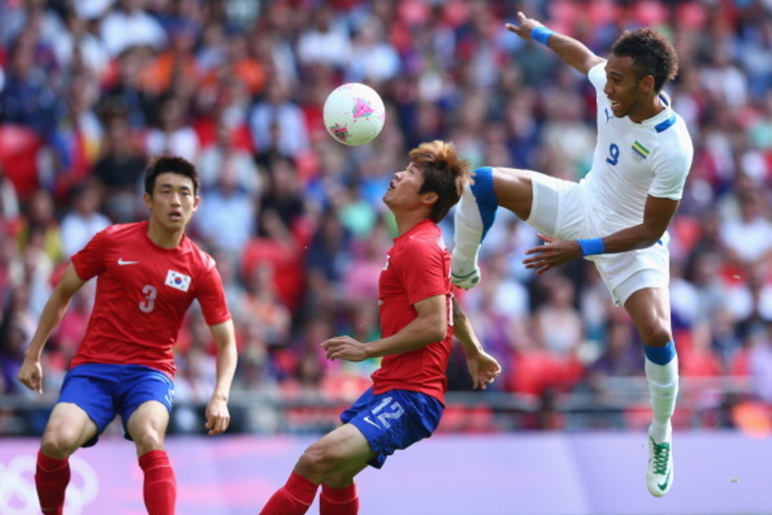 LONDON, ENGLAND - AUGUST 01: Seokho Hwang (C) of Korea Republic is challenged by Pierre Aubameyang (R) of Gabon during the Men's Football first round Group B Match between Korea Republic and Gabon on Day 5 of the London 2012 Olympic Games at Wembley Stad LONDON, ENGLAND - AUGUST 01: Seokho Hwang (C) of Korea Republic is challenged by Pierre Aubameyang (R) of Gabon during the Men's Football first round Group B Match between Korea Republic and Gabon on Day 5 of the London 2012 Olympic Games at Wembley Stad