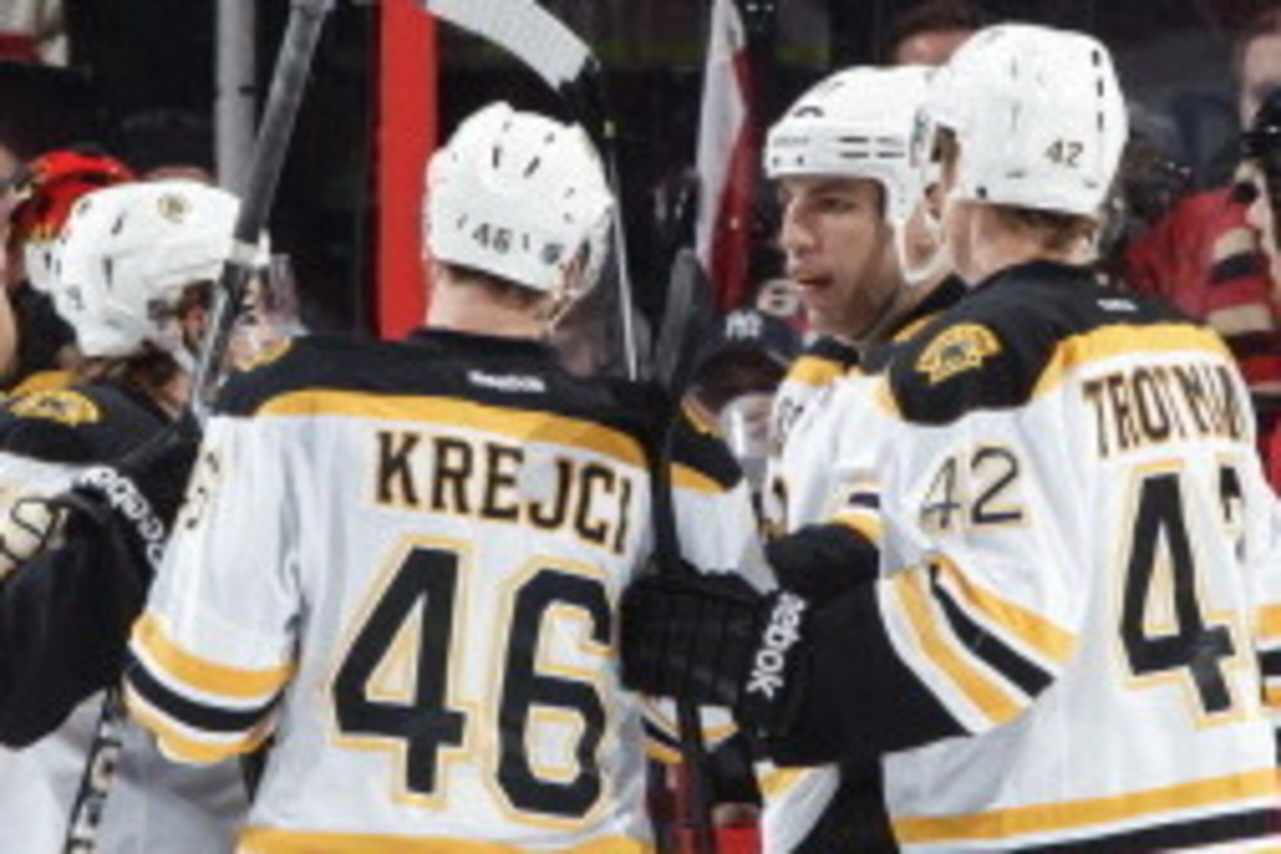 OTTAWA, ON - DECEMBER 28: David Warsofsky #79 of the Boston Bruins celebrates his first career NHL goal  with team mates Jarome Iginla #12, David Krejci #46, Zach Trotman #42 and Milan Lucic #17during an NHL game against the Ottawa Senators at Canadian Ti