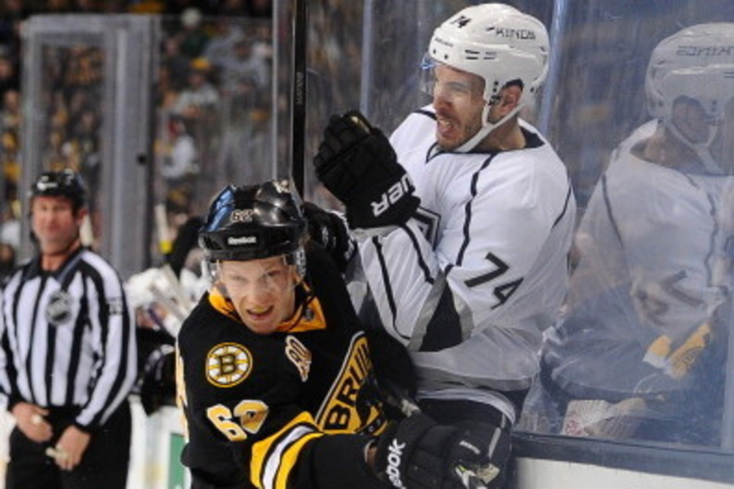 BOSTON, MA - JANUARY 20: Zach Trotman #62 of the Boston Bruins checks against Dwight King #74 of the Los Angeles Kings at the TD Garden on January 20, 2014 in Boston, Massachusetts.  (Photo by Brian Babineau/NHLI via Getty Images)