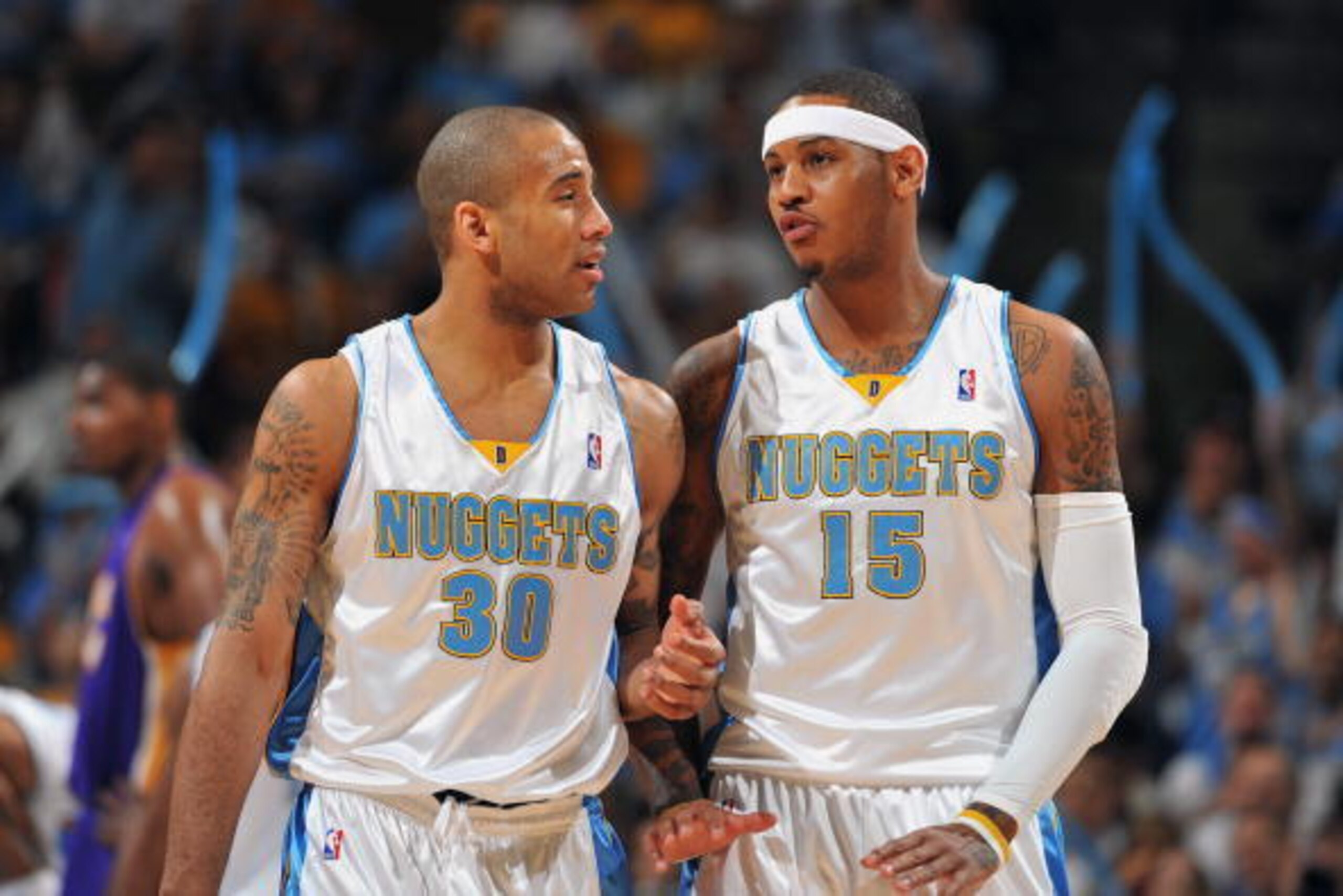 DENVER - MAY 23:  Dahntay Jones #30 and Carmelo Anthony #15 of the Denver Nuggets talk on the court in Game Three of the Western Conference Finals against the Los Angeles Lakers during the 2009 NBA Playoffs at the Pepsi Center on May 23, 2009 in Denver, C