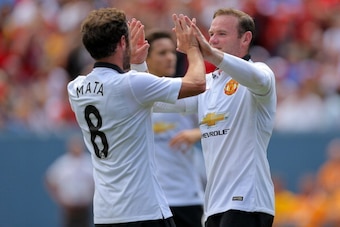 DENVER, CO - JULY 26: Wayne Rooney #10 of Manchester United celebrates his second goal with Juan Mata #8 during the first half of an International Champions Cup match against AS Roma at Sports Authority Field at Mile High on July 26, 2014 in Denver, Color