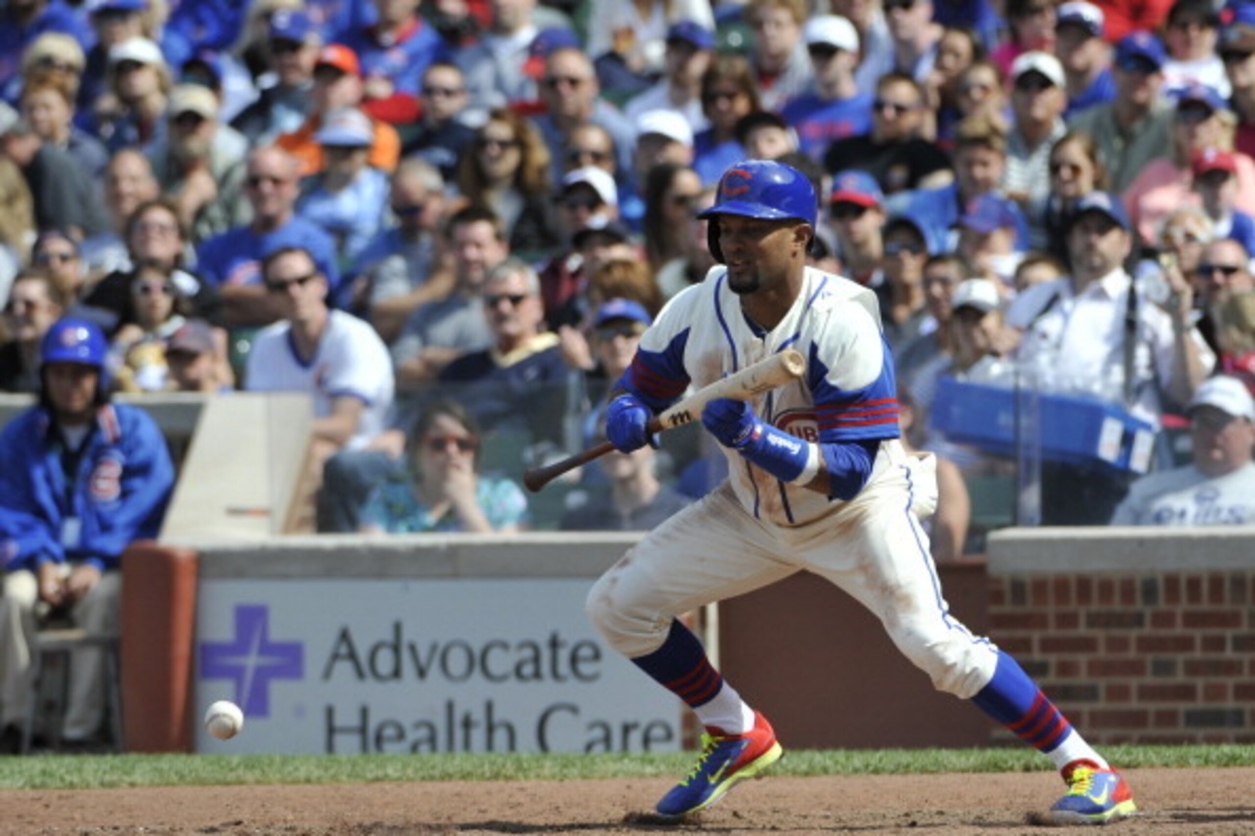 CHICAGO, IL - JUNE  08: Emilio Bonifacio #64 of the Chicago Cubs lays down a sacrifice bunt during the seventh inning against the Miami Marlins on June 8, 2014 at Wrigley Field in Chicago, Illinois. (Photo by David Banks/Getty Images)