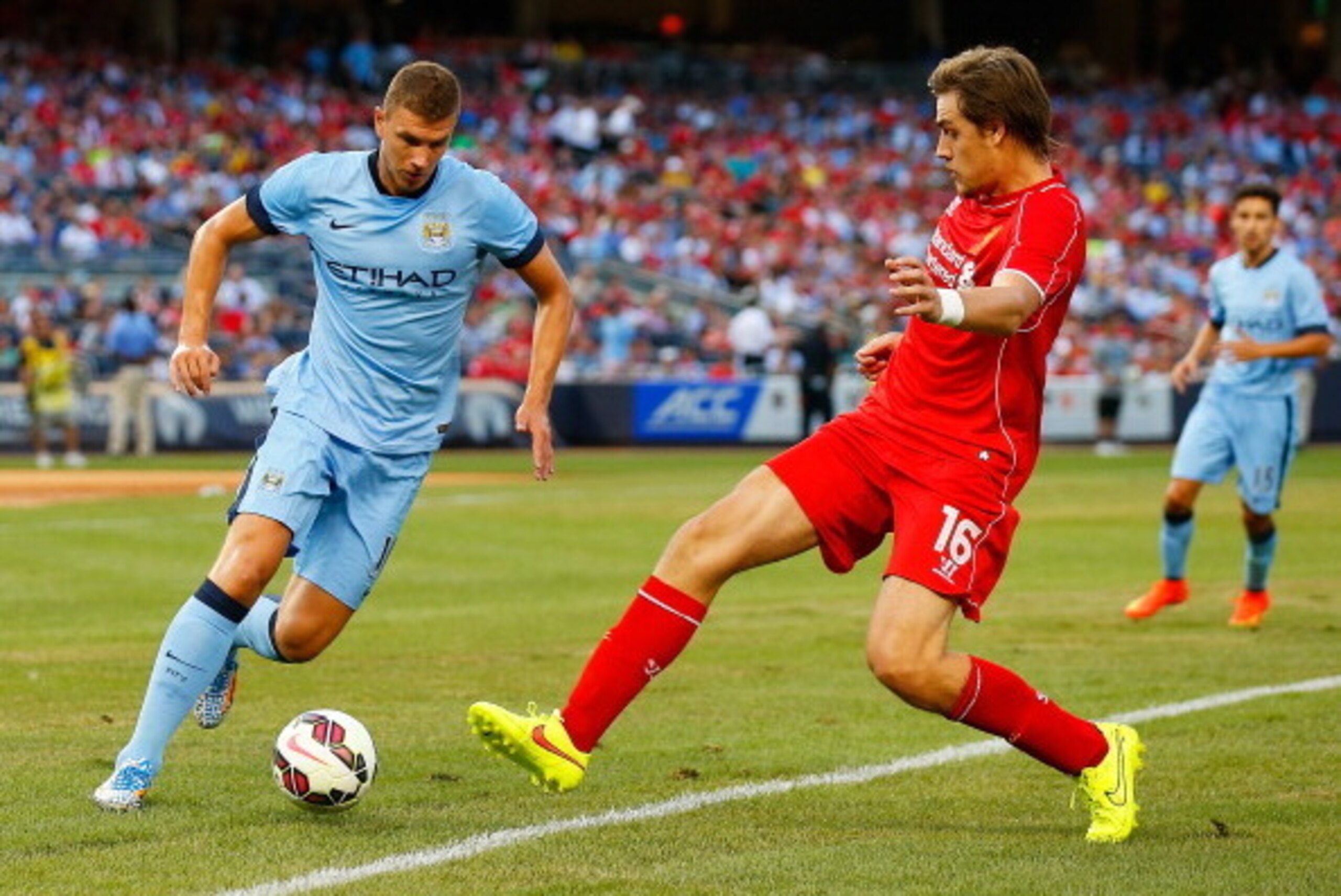 NEW YORK, NY - JULY 30:  Edin Dzeko #10 of Manchester City and Sebastian Coates #16 of Liverpool vie for the ball during the International Champions Cup 2014 at Yankee Stadium on July 30, 2014 in the Bronx borough of New York City.  (Photo by Mike Stobe/G