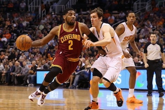 PHOENIX, AZ - MARCH 12:  Kyrie Irving #2 of the Cleveland Cavaliers drives the ball against Goran Dragic #1 of the Phoenix Suns during the first half of the NBA game at US Airways Center on March 12, 2014 in Phoenix, Arizona.  The Cavaliers defeated the S