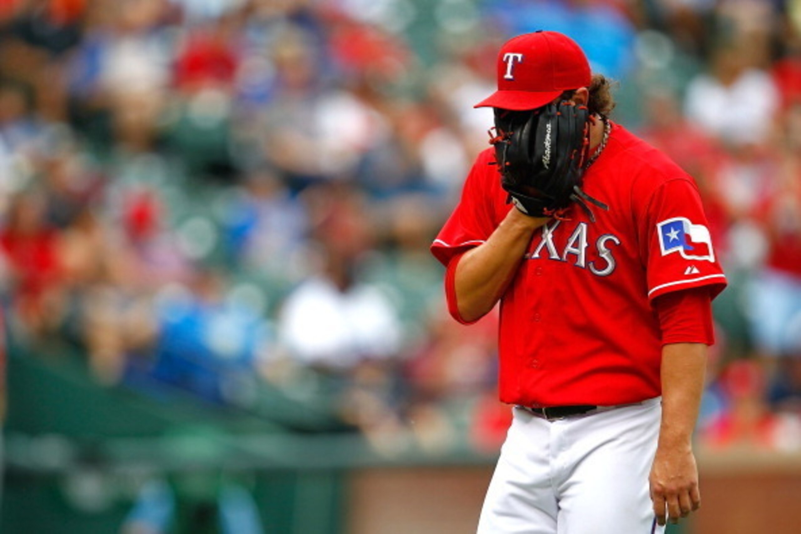 ARLINGTON, TX - SEPTEMBER 28:  Derek Holland #45 of the Texas Rangers looks down after pitching during a game against the Los Angeles Angels of Anaheim at Rangers Ballpark in Arlington on September 28, 2013 in Arlington, Texas.  (Photo by Sarah Glenn/Gett