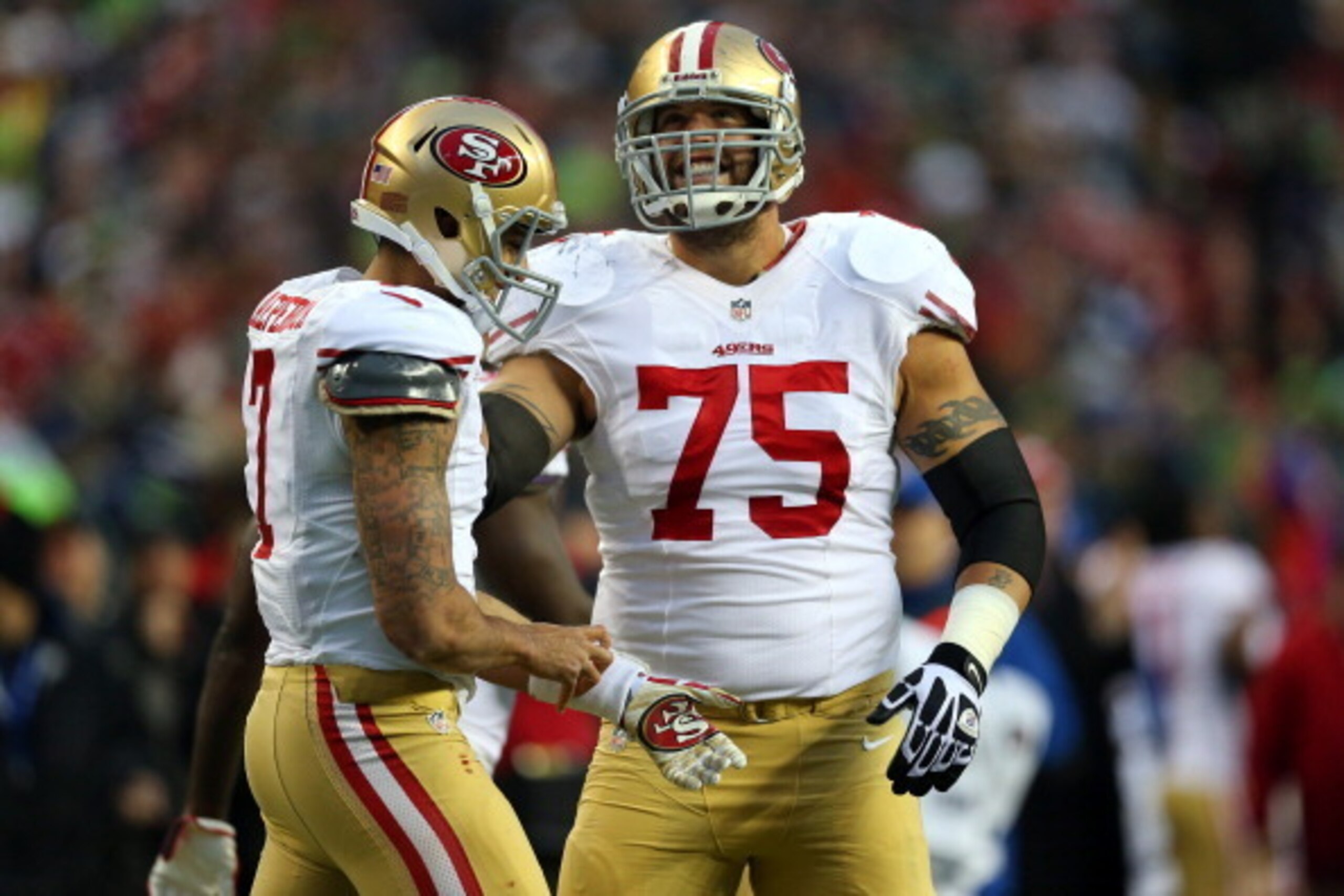 SEATTLE, WA - JANUARY 19:  (R-L) Guard Alex Boone #75 smiles alongisde quarterback Colin Kaepernick #7 of the San Francisco 49ers in the first half against the Seattle Seahawks during the 2014 NFC Championship at CenturyLink Field on January 19, 2014 in S