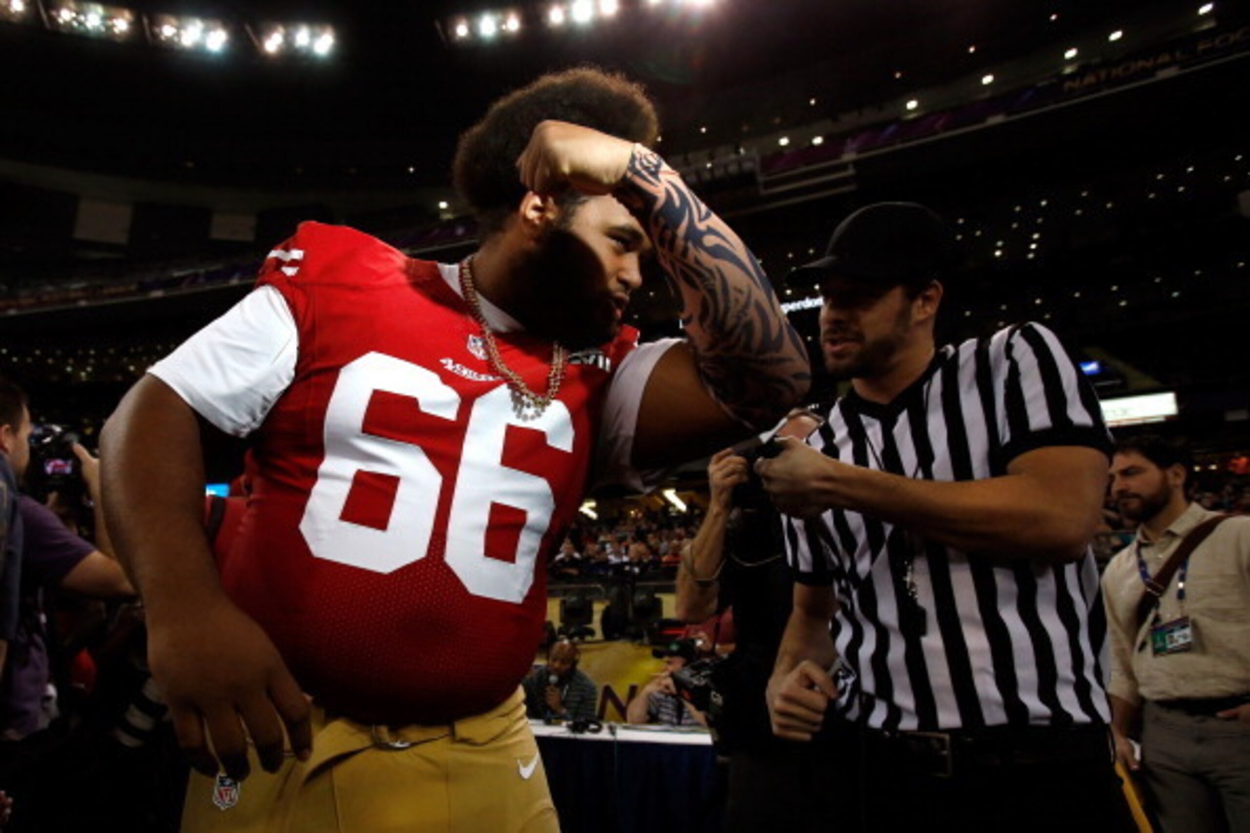 NEW ORLEANS, LA - JANUARY 29:  Joe Looney #66 of the San Francisco 49ers kisses his bicep as he is interviewed from the media during Super Bowl XLVII Media Day ahead of Super Bowl XLVII at the Mercedes-Benz Superdome on January 29, 2013 in New Orleans, Lo