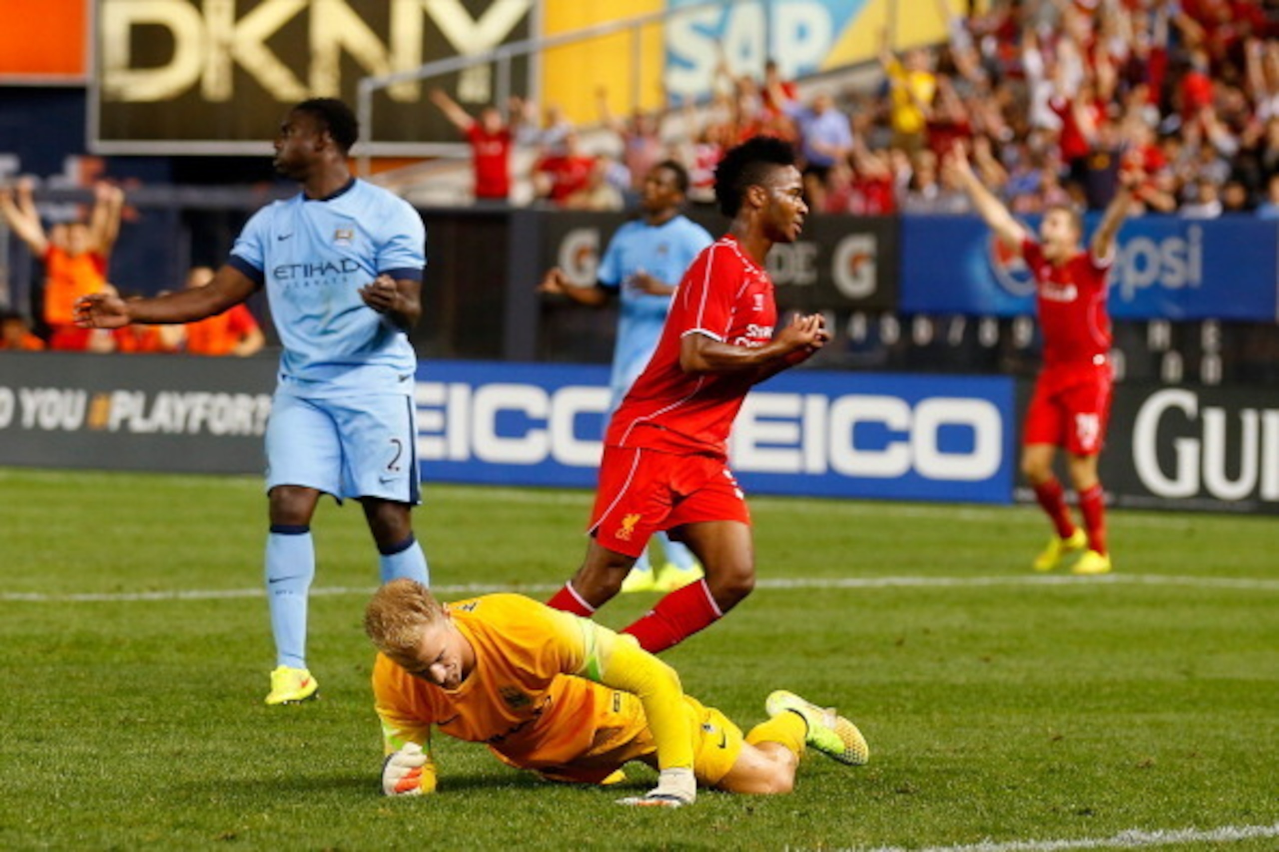 NEW YORK, NY - JULY 30:  Raheem Sterling #31 of Liverpool celebrates his goal in the 85th minute as Joe Hart #1 of Manchester City looks on during the International Champions Cup 2014 at Yankee Stadium on July 30, 2014 in the Bronx borough of New York Cit
