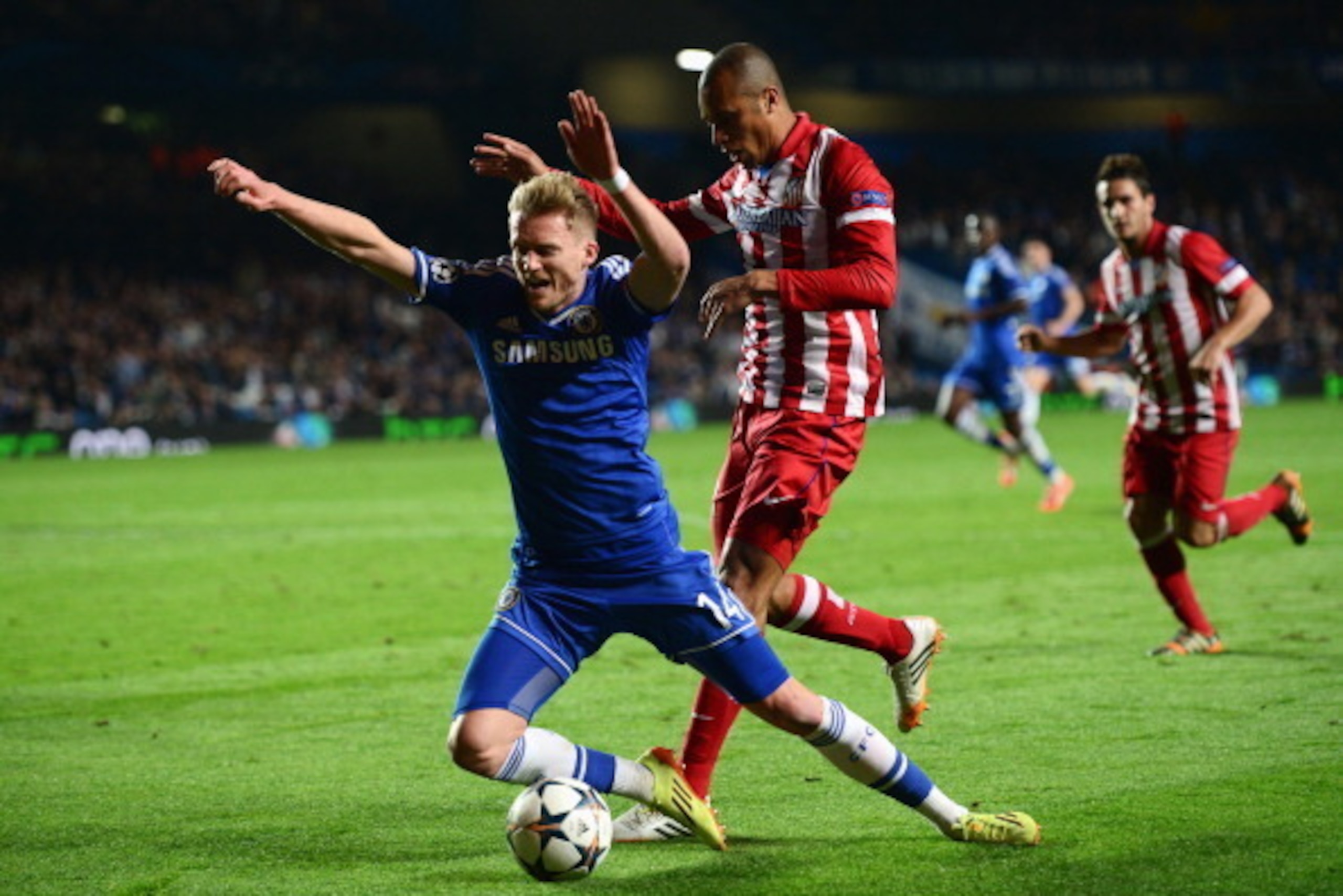 LONDON, ENGLAND - APRIL 30:  Andre Schurrle of Chelsea goes to ground under a challenge from Miranda of Club Atletico de Madrid during the UEFA Champions League semi-final second leg match between Chelsea and Club Atletico de Madrid at Stamford Bridge on 