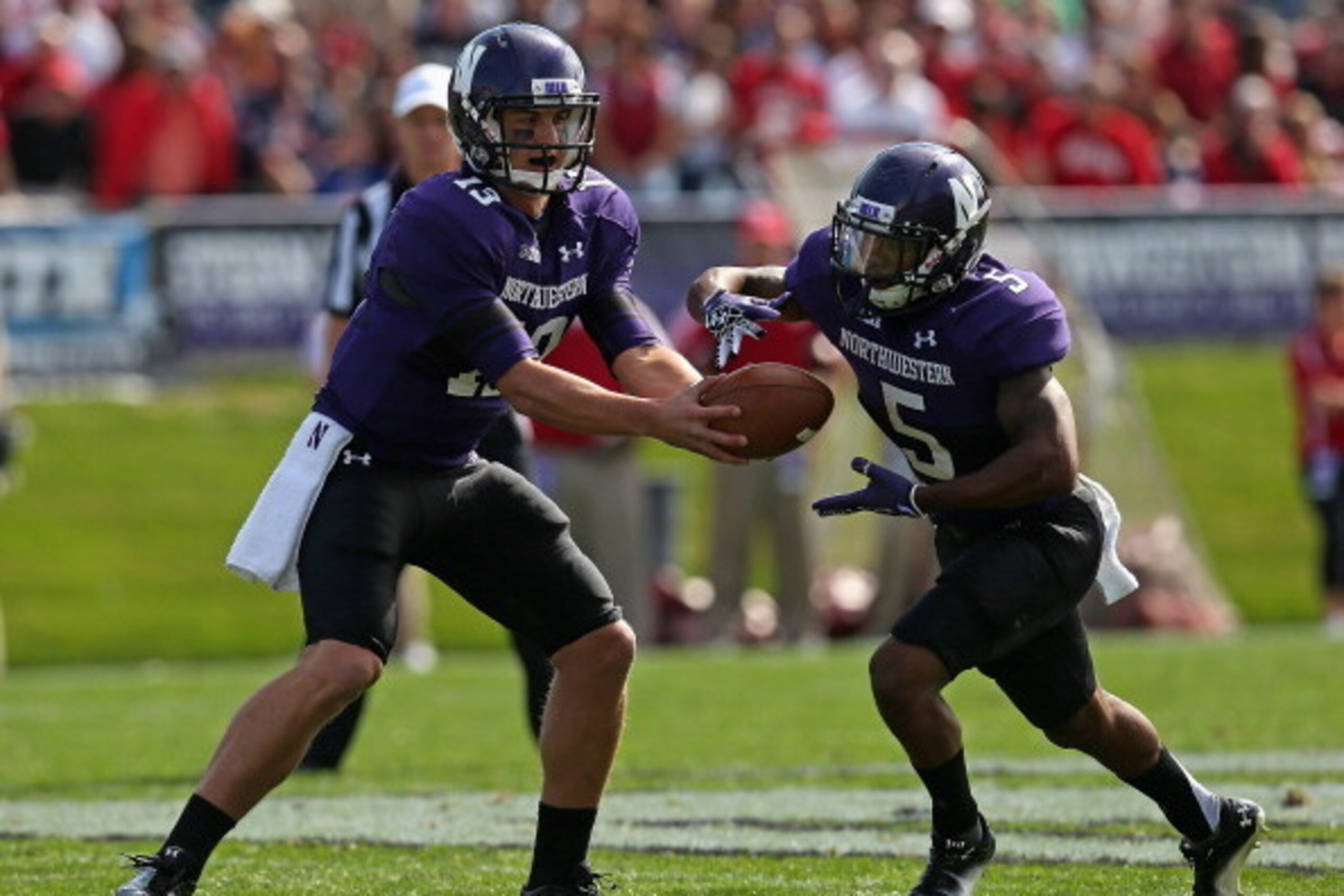EVANSTON, IL - SEPTEMBER 29: Trevor Siemian #13 of the Northwestern Wildcats hands off to Venric Mark #5 against the Indiana Hoosiers at Ryan Field on September 29, 2012 in Evanston, Illinois. Northwestern defeated Indiana 44-29.  (Photo by Jonathan Danie