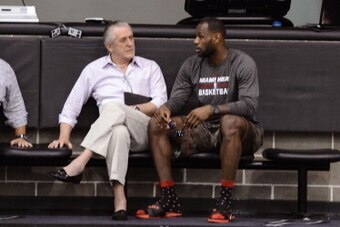 SAN ANTONIO, TX JUNE 6: Miami Heat owner Micky Arison, President Pat Riley and LeBron James speak during practice as part of the 2014 NBA Finals on June 6, 2014 at the Spurs Practice Facility in San Antonio, Texas. NOTE TO USER: User expressly acknowledge