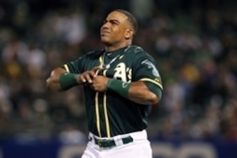 Jul 23, 2014; Oakland, CA, USA; Oakland Athletics left fielder Yoenis Cespedes (52) pulls on his finger after falling at home plate after swinging against the Houston Astros in the sixth inning of their MLB baseball game at O.co Coliseum. Mandatory Credit
