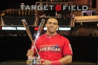 Jul 14, 2014; Minneapolis, MN, USA; American League outfielder Yoenis Cespedes (52) of the Oakland Athletics poses with the championship trophy after winning the 2014 Home Run Derby the day before the MLB All Star Game at Target Field. Mandatory Credit: J