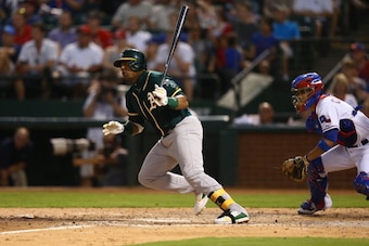 ARLINGTON, TX - JULY 25:  Yoenis Cespedes #52 of the Oakland Athletics hits in a run against the Texas Rangers in the sixth inning at Globe Life Park in Arlington on July 25, 2014 in Arlington, Texas.  (Photo by Ronald Martinez/Getty Images)