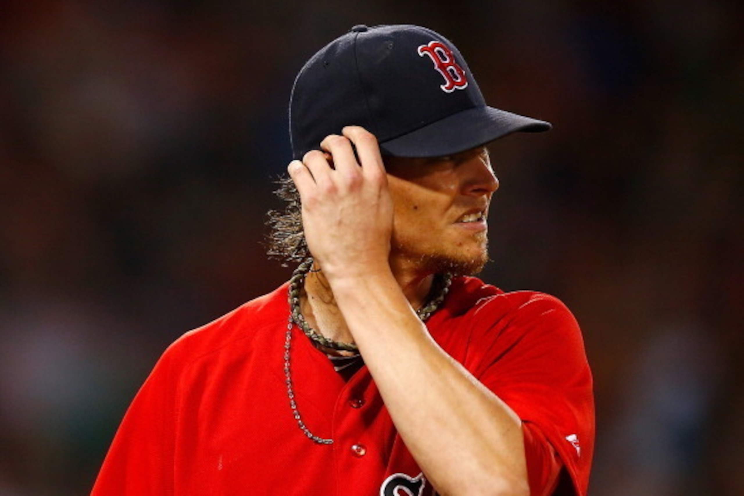 BOSTON, MA - JULY 18:  Clay Buchholz #11 of the Boston Red Sox walks back to the dugout after pitching against the Kansas City Royals during the game at Fenway Park on July 18, 2014 in Boston, Massachusetts.  (Photo by Jared Wickerham/Getty Images)