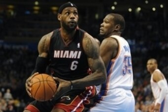 Feb 20, 2014; Oklahoma City, OK, USA; Miami Heat small forward LeBron James (6) handles the ball while being guarded by Oklahoma City Thunder small forward Kevin Durant (35) during the first quarter at Chesapeake Energy Arena. Mandatory Credit: Mark D. Sm