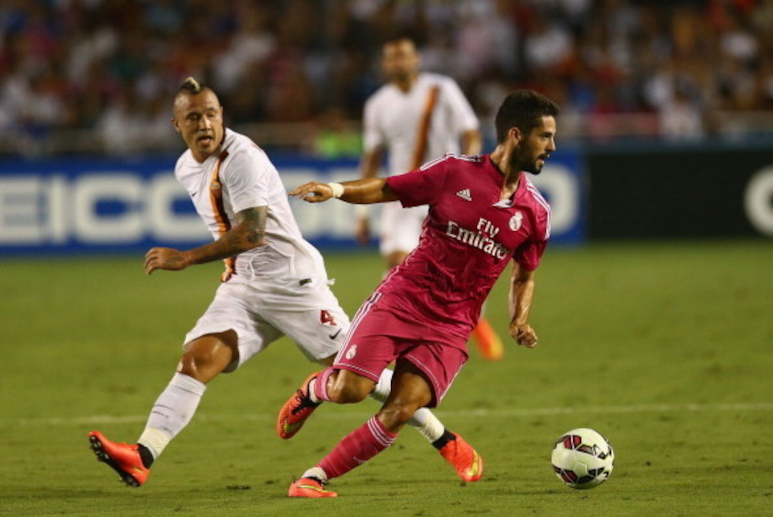 DALLAS, TX - JULY 29: Isco #23 of Real Madrid dribbles the ball past Radja Nainggolan #4 of AS Roma during a Guinness International Champions Cup 2014 game at Cotton Bowl on July 29, 2014 in Dallas, Texas. (Photo by Ronald Martinez/Getty Images) DALLAS, TX - JULY 29: Isco #23 of Real Madrid dribbles the ball past Radja Nainggolan #4 of AS Roma during a Guinness International Champions Cup 2014 game at Cotton Bowl on July 29, 2014 in Dallas, Texas. (Photo by Ronald Martinez/Getty Images)