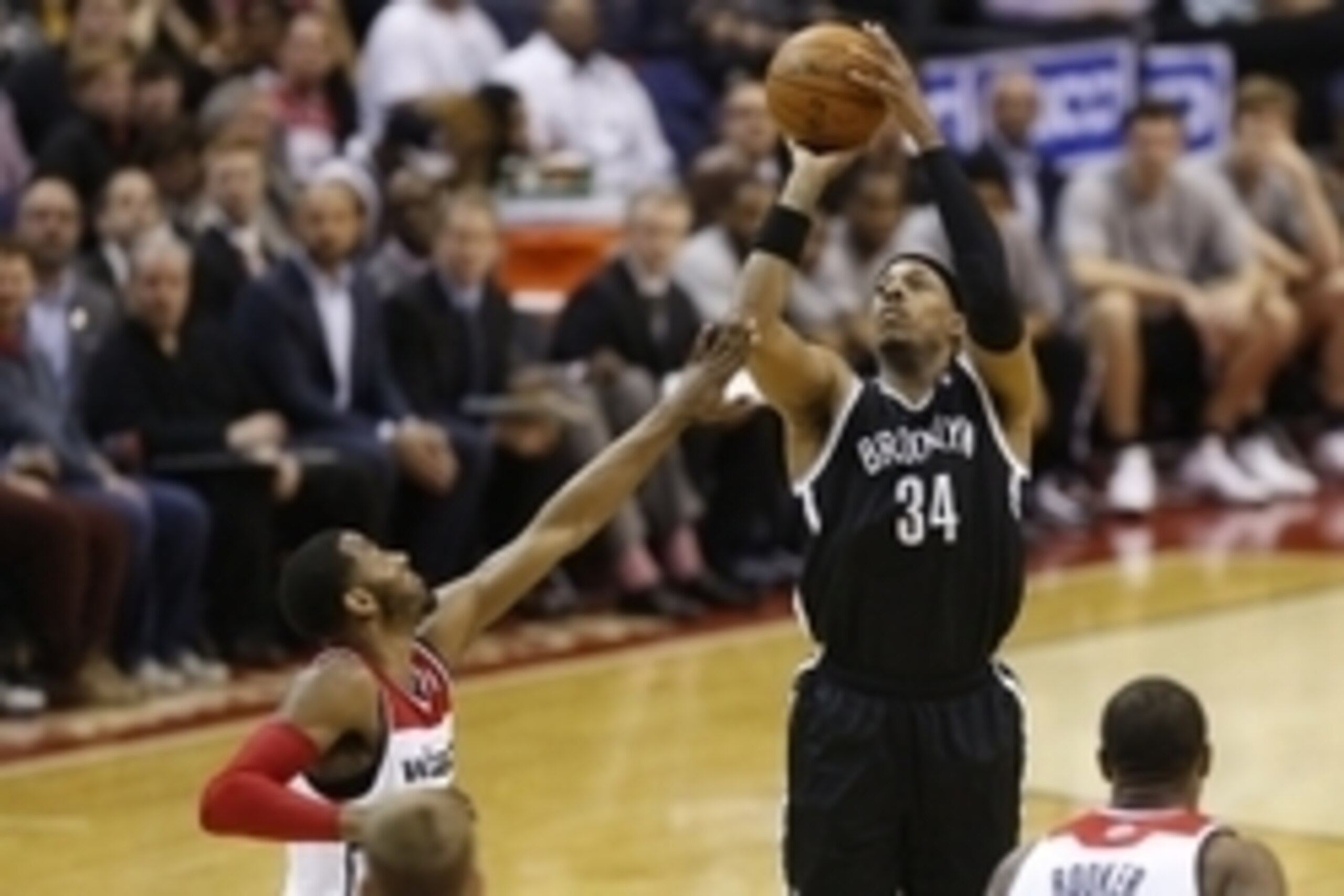 Mar 15, 2014; Washington, DC, USA; Brooklyn Nets forward Paul Pierce (34) shoots the ball over Washington Wizards guard John Wall (2) in the third quarter at Verizon Center. The Wizards won 101-94. Mandatory Credit: Geoff Burke-USA TODAY Sports