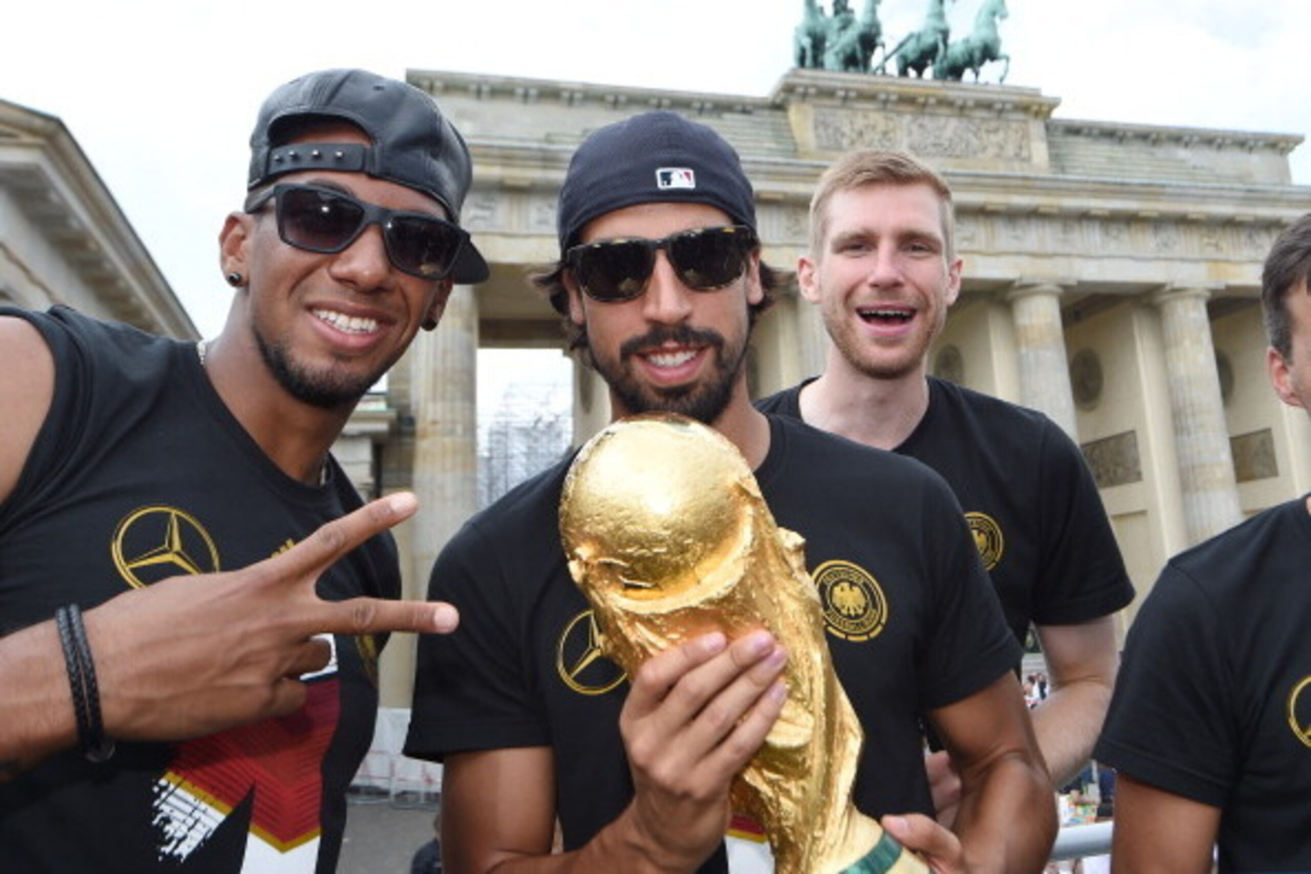 BERLIN, GERMANY - JULY 15: Jerome Boateng, Sami Khedira and  Per Mertersacker celebrate during the German team victory ceremony on July 15, 2014 in Berlin, Germany. Germany won the 2014 FIFA World Cup Brazil match against Argentina in Rio de Janeiro on Ju