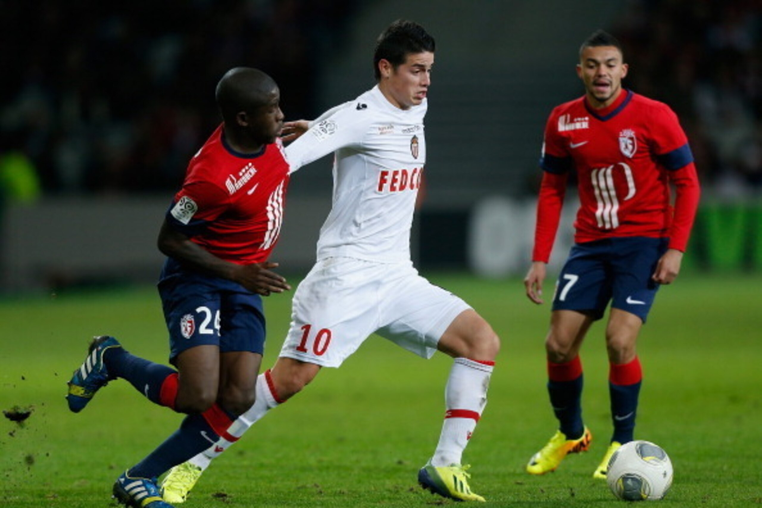 LILLE, FRANCE - NOVEMBER 03:  James David Rodriguez Rubio of Monaco (C) is challenged by Antonio Mavuba of Lille (L) during the French Ligue 1 match between OSC Lille and AS Monaco at the Grand Stade Metropole Villeneuve-d'Ascq on November 3, 2013 in Lill