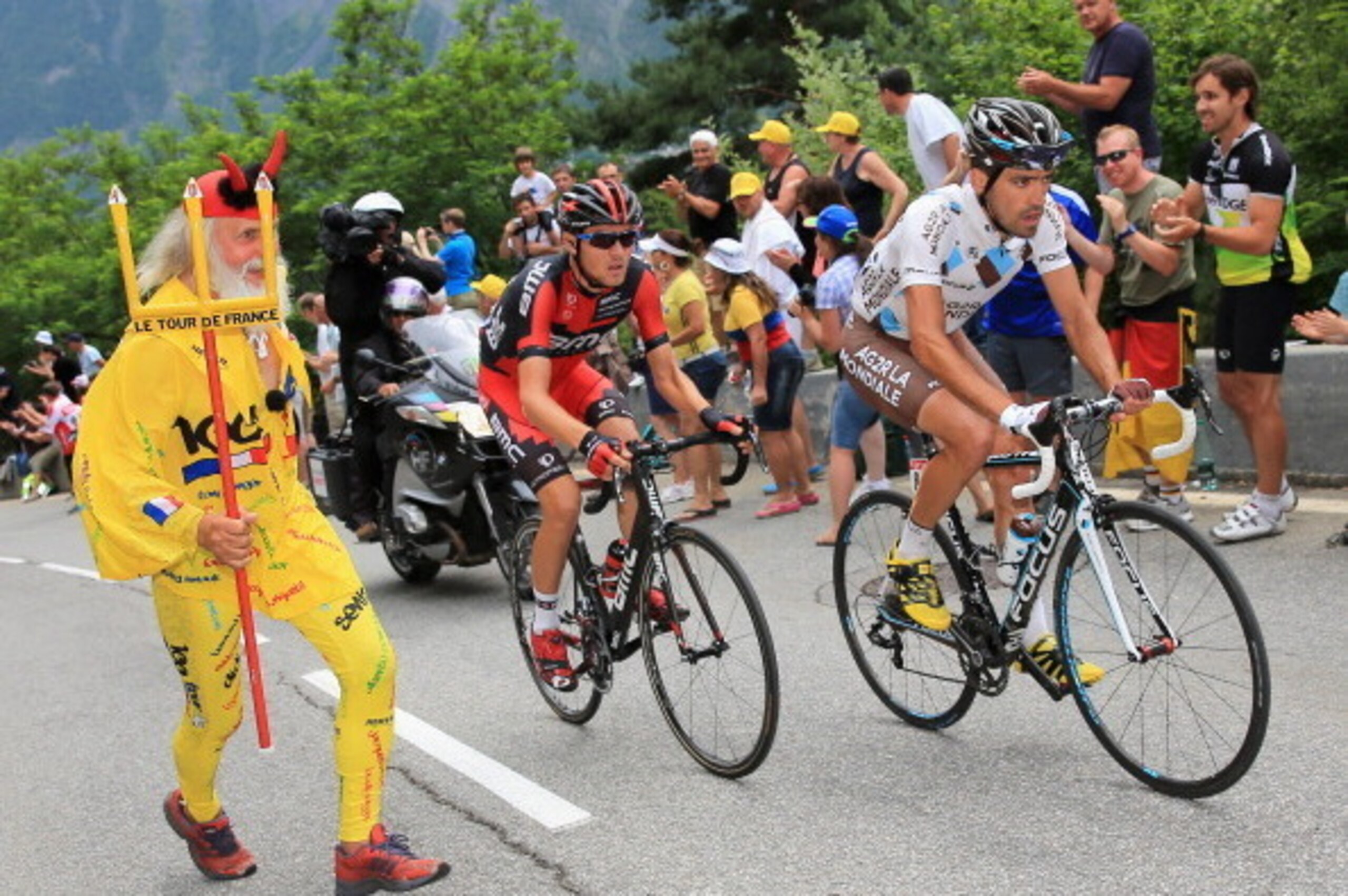 ALPE D'HUEZ, FRANCE - JULY 18:  Christophe Riblon (R) of France riding for AG2R La Mondiale leads Tejay van Garderen (C) of the United States riding for BMC Racing as they are chased by El Diablo (L) on the second climb of l'Alpe-d'Huez during stage eight