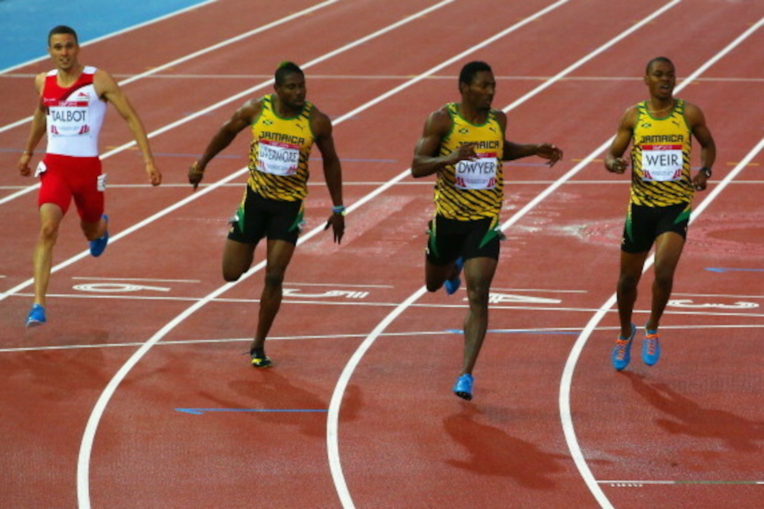 GLASGOW, SCOTLAND - JULY 31:  (L-R) Danny Talbot of England, Bronze medalist Jason Livermore of Jamaica, Gold medalist Rasheed Dwyer of Jamaica and Silver medalist Warren Weir of Jamaica sprint to the line in the Men's 200 metres Final at Hampden Park dur