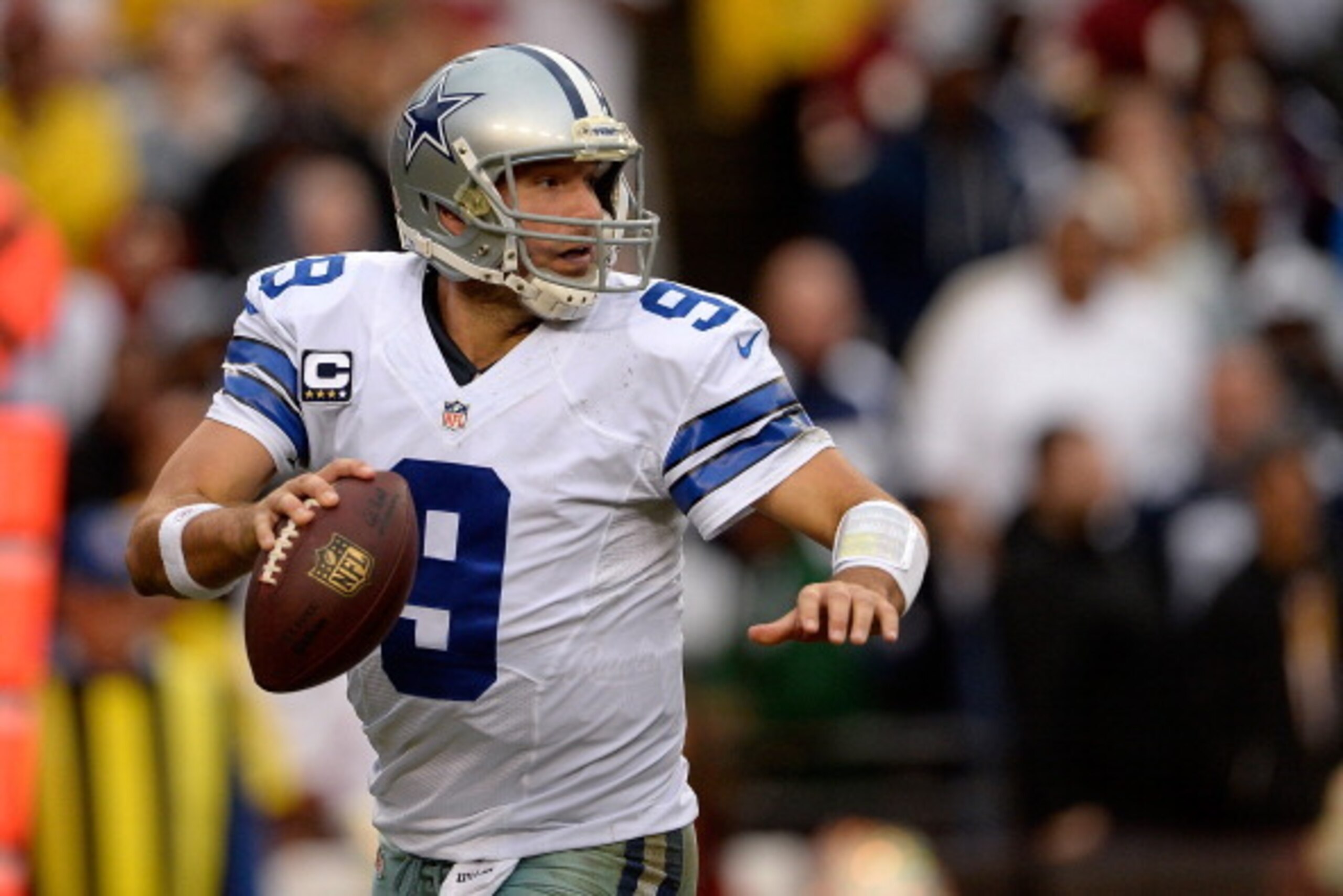 LANDOVER, MD - DECEMBER 22: Quarterback Tony Romo #9 of the Dallas Cowboys scrambles with the ball in the second half during an NFL game against the Washington Redskins at FedExField on December 22, 2013 in Landover, Maryland. (Photo by Patrick McDermot LANDOVER, MD - DECEMBER 22: Quarterback Tony Romo #9 of the Dallas Cowboys scrambles with the ball in the second half during an NFL game against the Washington Redskins at FedExField on December 22, 2013 in Landover, Maryland. (Photo by Patrick McDermot