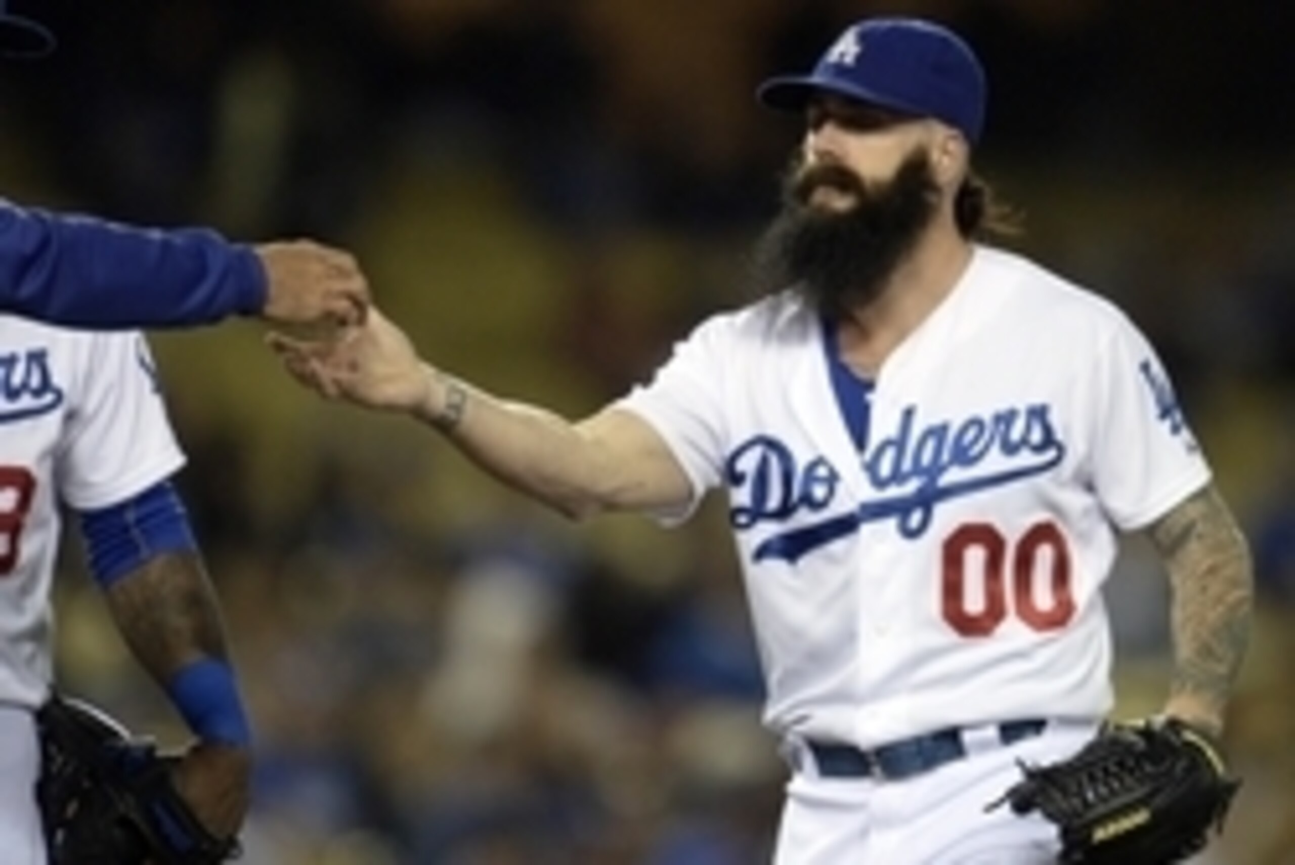 Jun 16, 2014; Los Angeles, CA, USA; Los Angeles Dodgers reliever Brian Wilson takes the ball from manager Don Mattingly (8) as he comes in to pitch in the eighth inning against the Colorado Rockies at Dodger Stadium. Mandatory Credit: Robert Hanashiro-USA