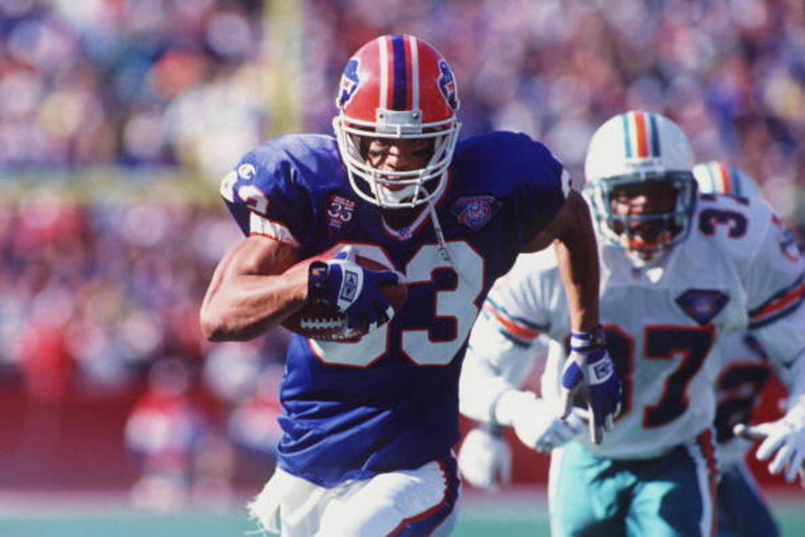 9 OCT 1994:  BUFFALO BILLS WIDE RECEIVER ANDRE REED ON A RUN AS MIAMI DOLPHINS DEFENDER J.B. BROWN #37 PURSUES DURING THE BILLS 21-11 WIN AT RICH STADIUM IN ORCHARD PARK, NEW YORK. Mandatory Credit: Rick Stewart/ALLSPORT