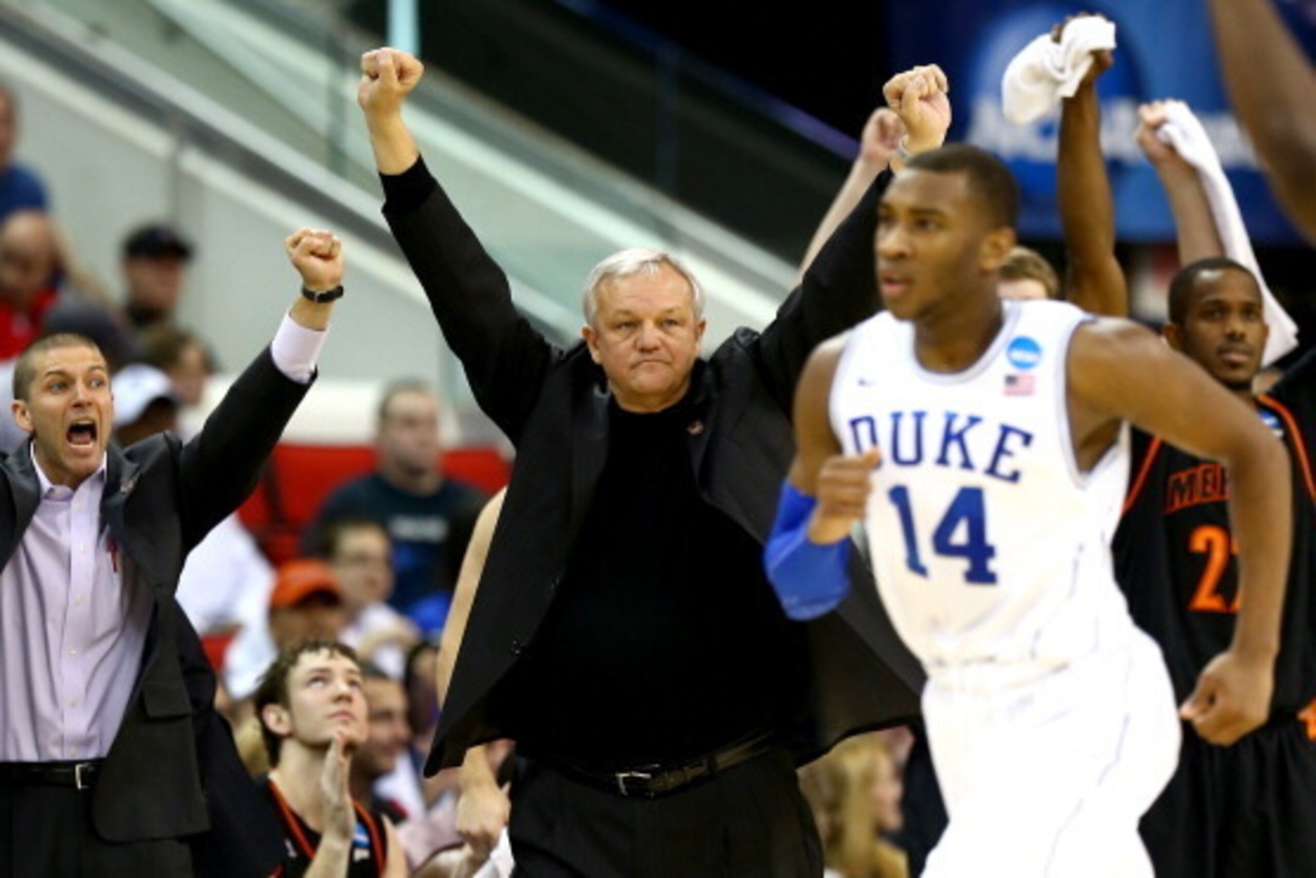 RALEIGH, NC - MARCH 21:  Head coach Bob Hoffman of the Mercer Bears reacts as Rasheed Sulaimon #14 of the Duke Blue Devils runs by during the Second Round of the 2014 NCAA Basketball Tournament at PNC Arena on March 21, 2014 in Raleigh, North Carolina.  (