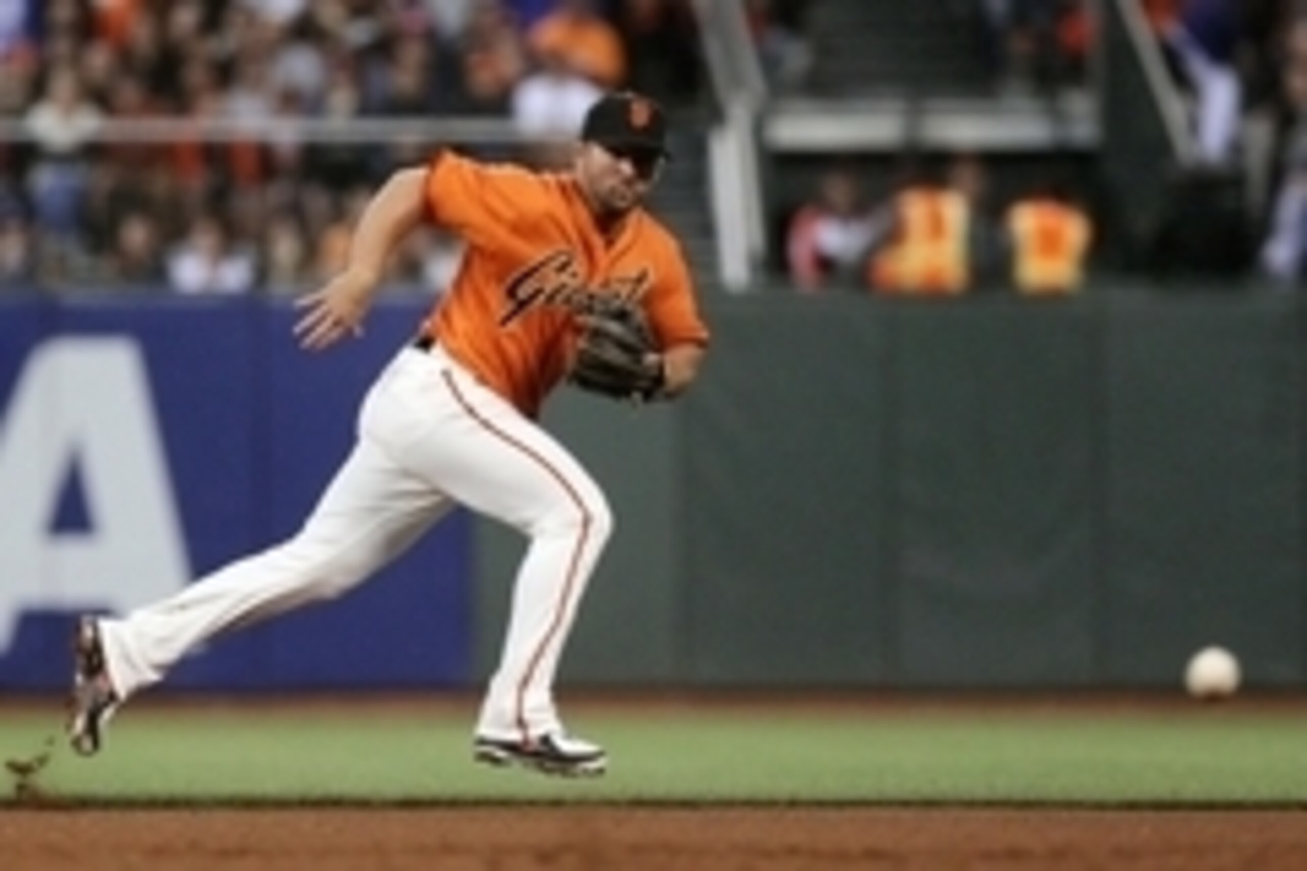 Jul 25, 2014; San Francisco, CA, USA; San Francisco Giants second baseman Dan Uggla (22) chases a ground ball in the fourth inning of their MLB baseball game with the Los Angeles Dodgers at AT&T Park. Mandatory Credit: Lance Iversen-USA TODAY Sports