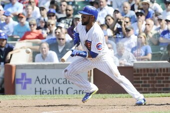 CHICAGO, IL - MAY 21: Emilio Bonifacio #64 of the Chicago Cubs bunts and drives in an RBI during the seventh inning against the New York Yankees  on May 21, 2014 at Wrigley Field in Chicago, Illinois.  (Photo by David Banks/Getty Images)