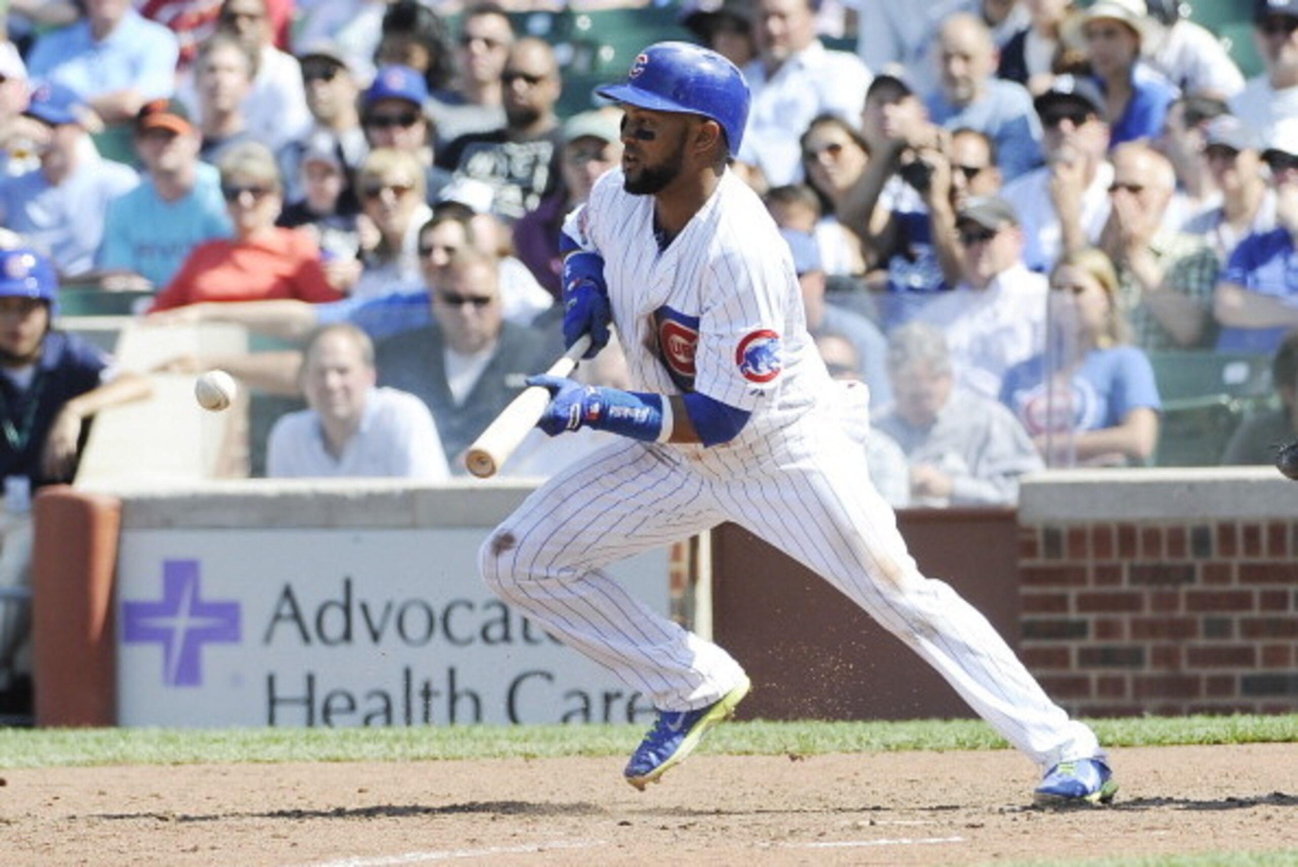 CHICAGO, IL - MAY 21: Emilio Bonifacio #64 of the Chicago Cubs bunts and drives in an RBI during the seventh inning against the New York Yankees  on May 21, 2014 at Wrigley Field in Chicago, Illinois.  (Photo by David Banks/Getty Images)