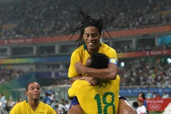 SHANGHAI, CHINA - AUGUST 22:  Jo of Brazil is celebrated by Ronaldinho and Marcelo after scoring the third goal during the Bronze Medal Match between Brazil and Belgium at Shanghai Stadium on Day 14 of the Beijing 2008 Olympic Games on August 22, 2008 in 