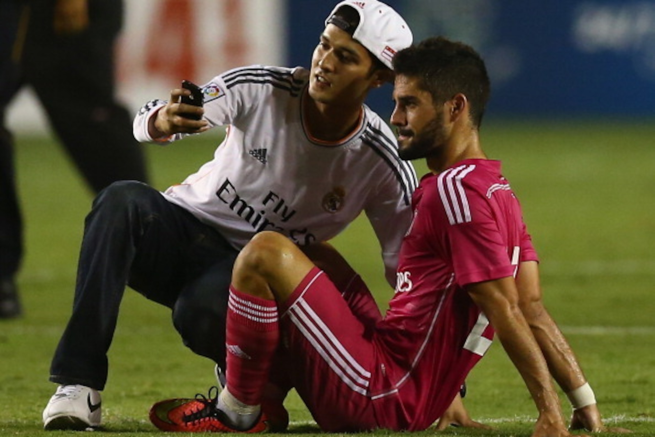 DALLAS, TX - JULY 29:  Isco #23 of Real Madrid takes a photo with a fan, after fans disrupted the game against AS Roma during a Guinness International Champions Cup 2014 game at Cotton Bowl on July 29, 2014 in Dallas, Texas.  (Photo by Ronald Martinez/Get