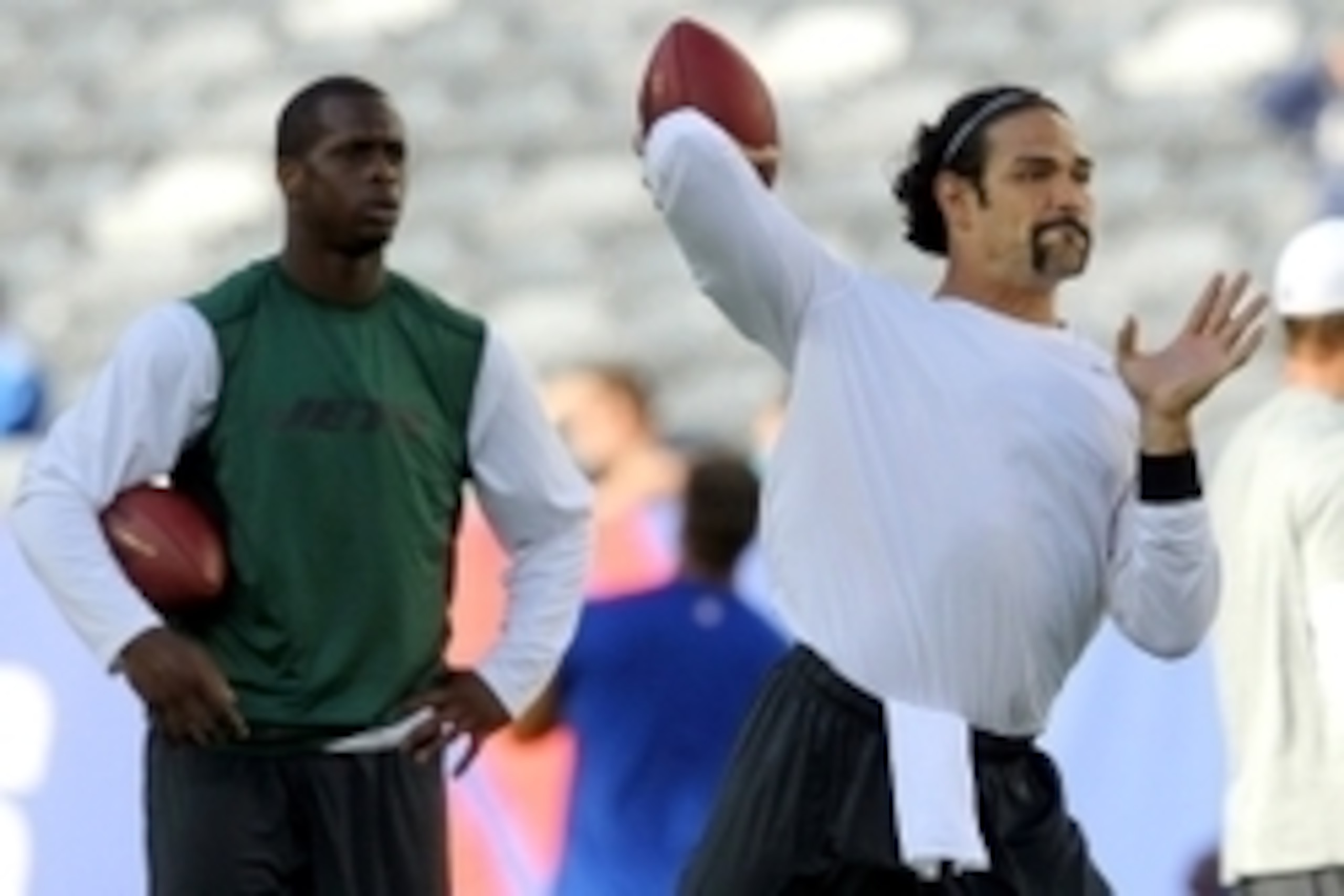 Aug 24, 2013; East Rutherford, NJ, USA; New York Jets quarterback Mark Sanchez (6) drops back to pass in front of New York Jets quarterback Geno Smith (7) during warmups before a game against the New York Giants at MetLife Stadium. Mandatory Credit: Brad 
