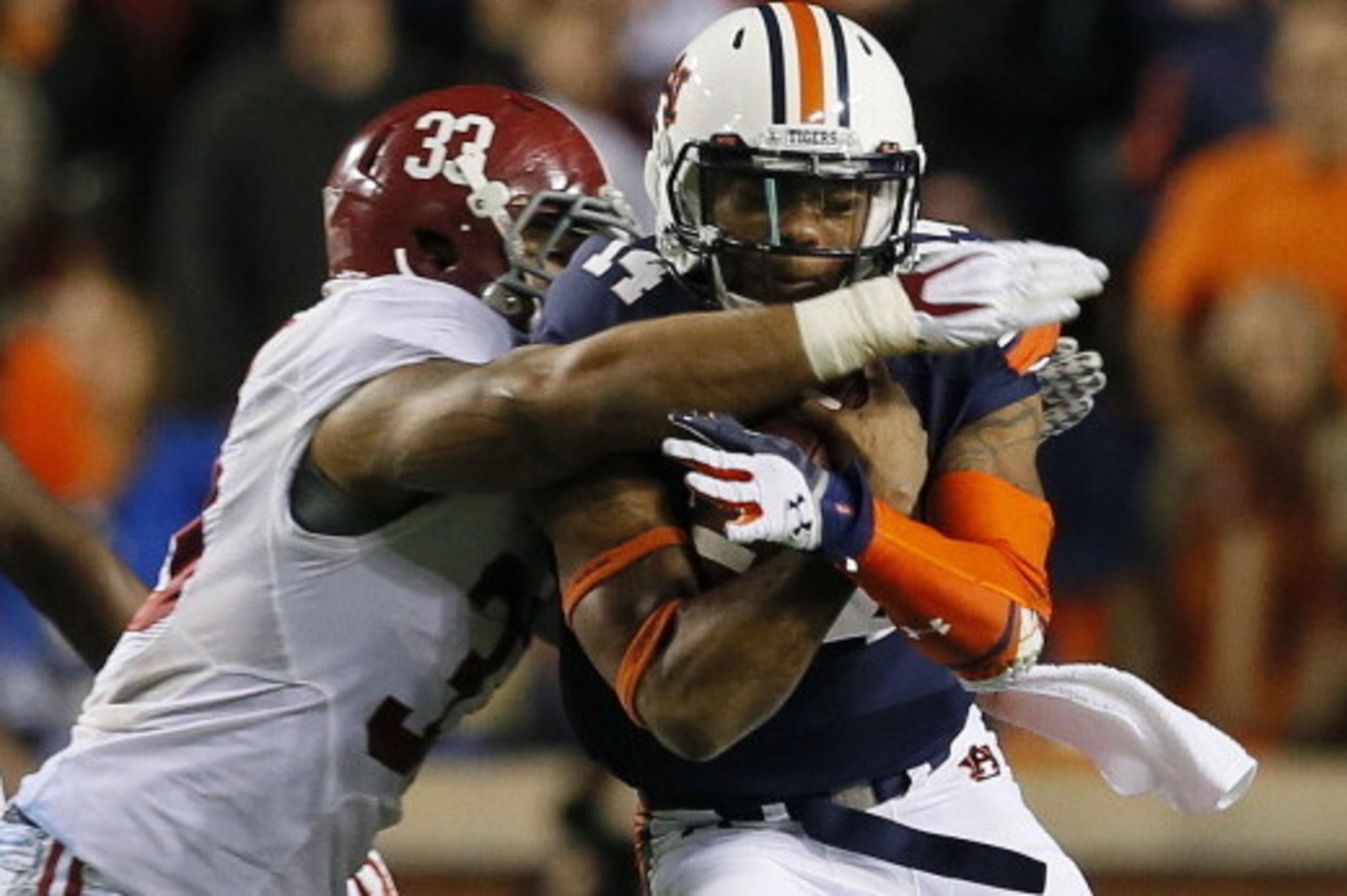 AUBURN, AL - NOVEMBER 30:  Nick Marshall #14 of the Auburn Tigers is tackled by Trey DePriest #33 of the Alabama Crimson Tide in the third quarter at Jordan-Hare Stadium on November 30, 2013 in Auburn, Alabama.  (Photo by Kevin C. Cox/Getty Images)