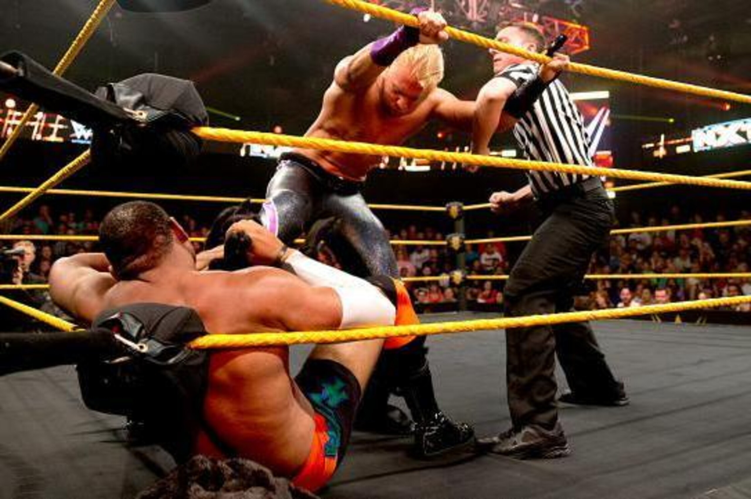 Tyler Breeze attacks Angelo Dawkins in the corner.