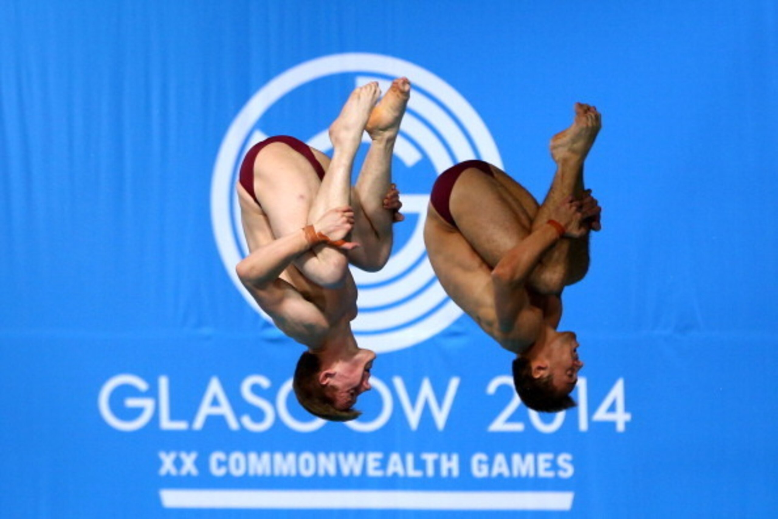 EDINBURGH, SCOTLAND - AUGUST 01:  Tom Daley and Denny James of England compete in the Men's Synchronised 10m Platform Final at Royal Commonwealth Pool during day nine of the Glasgow 2014 Commonwealth Games on August 1, 2014 in Edinburgh, Scotland.  (Photo