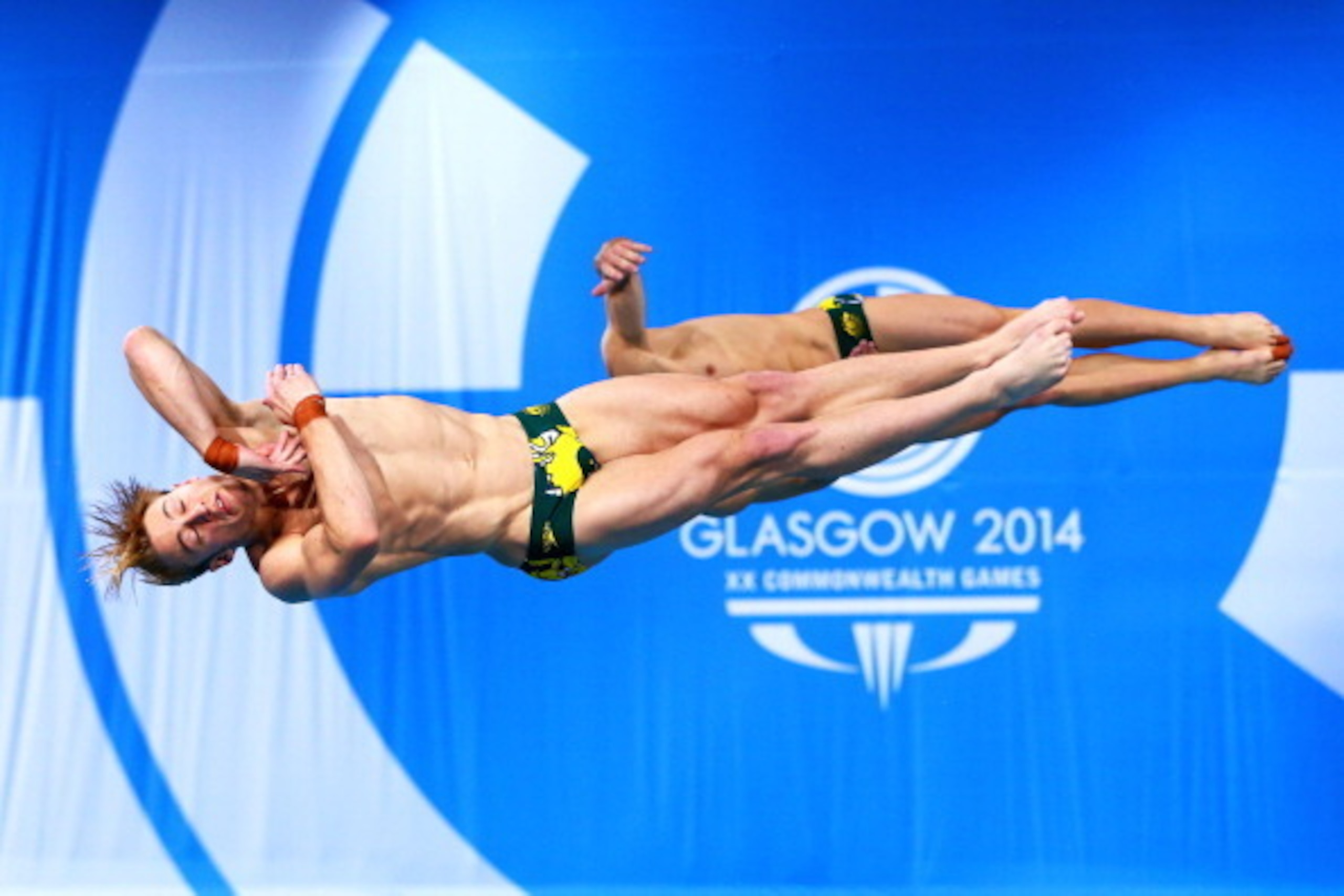 EDINBURGH, SCOTLAND - AUGUST 01: Matthew Mitcham and Grant Nel of Australia compete in the Men's Synchronised 3m Springboard Final at Royal Commonwealth Pool during day nine of the Glasgow 2014 Commonwealth Games on August 1, 2014 in Edinburgh, Scotland. 